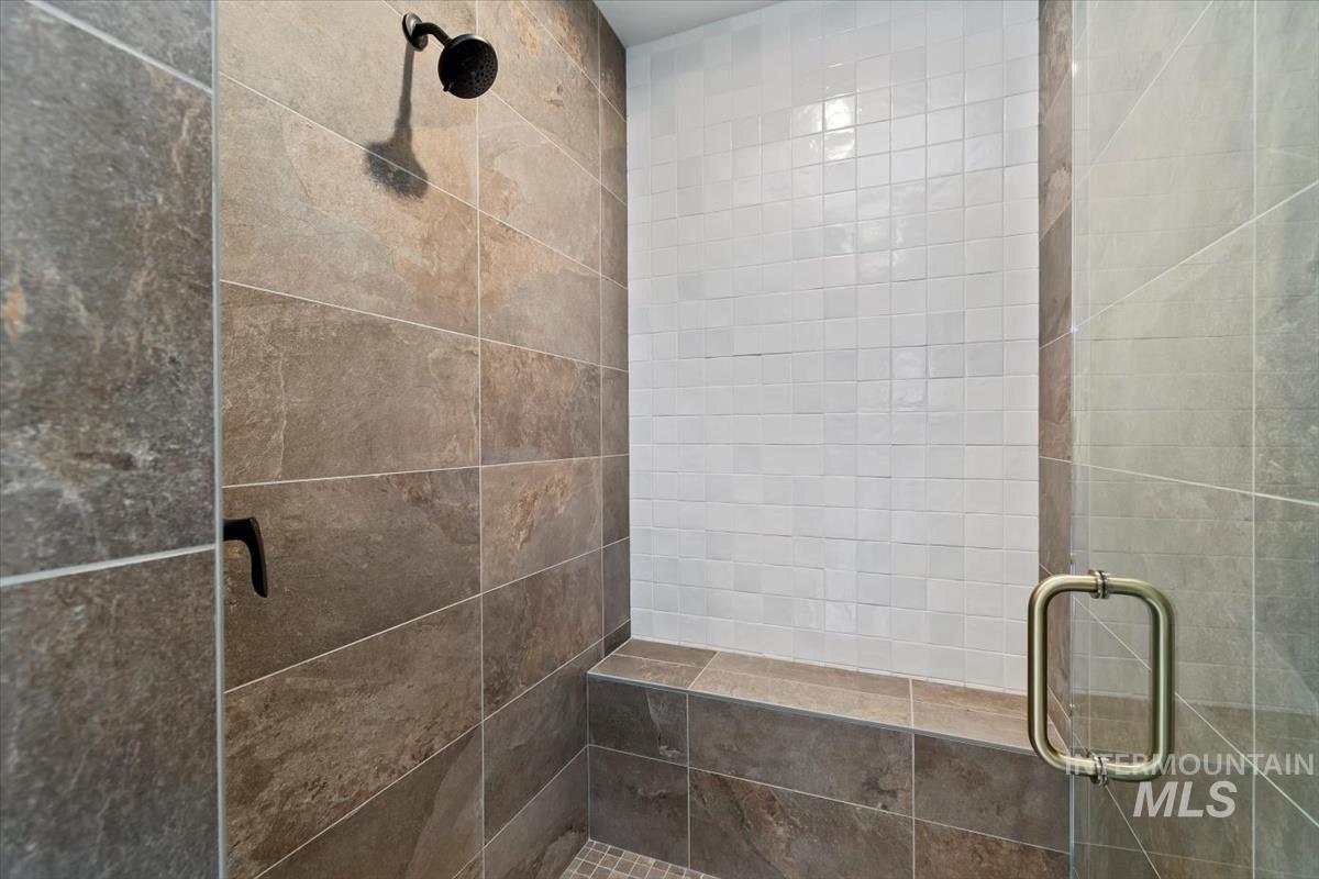 Full bathroom featuring a shower stall