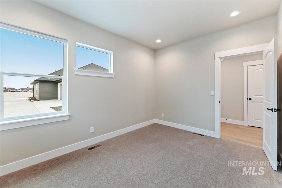 Unfurnished room with light carpet and recessed lighting