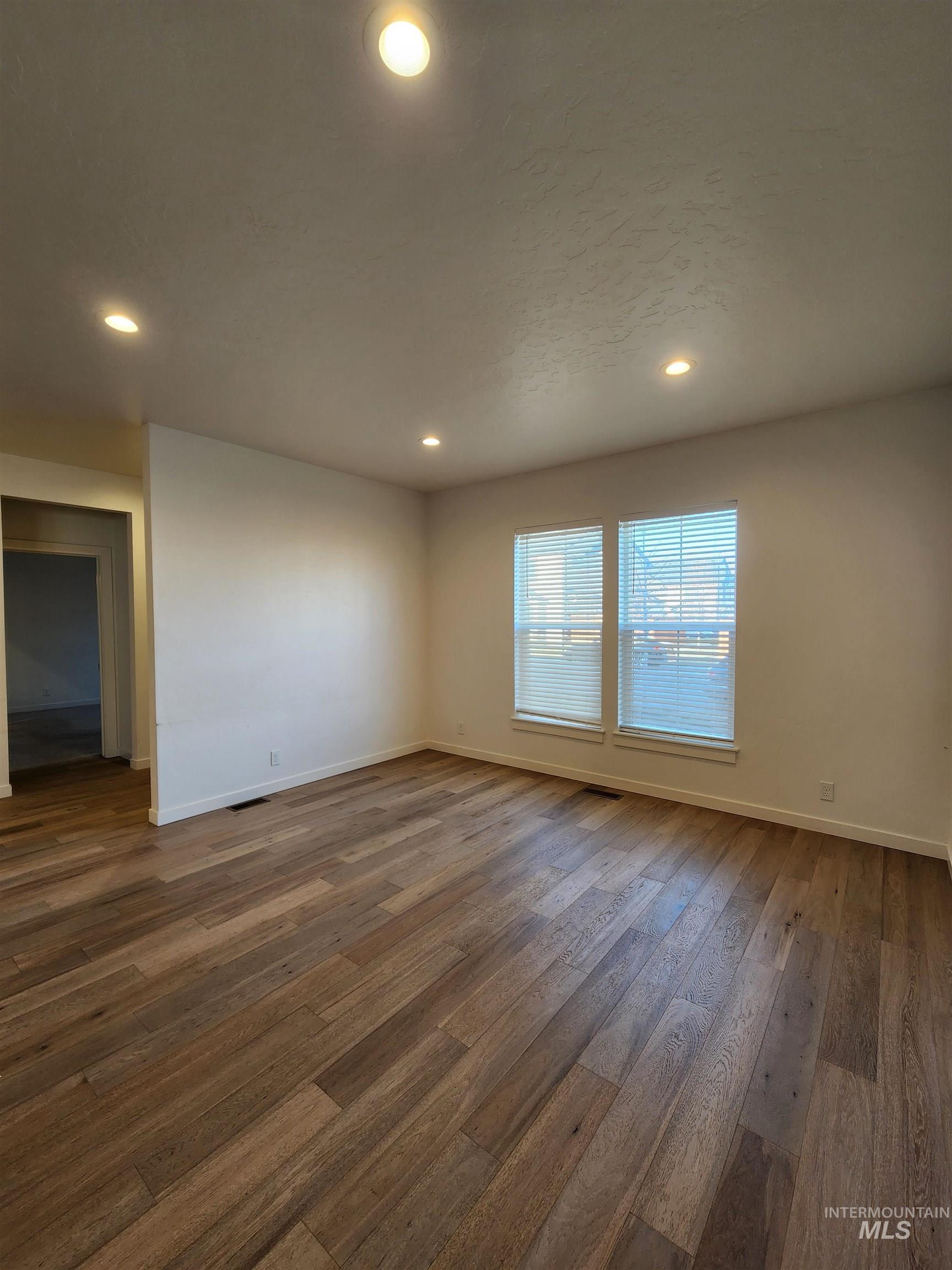 Unfurnished room featuring wood-type flooring and recessed lighting