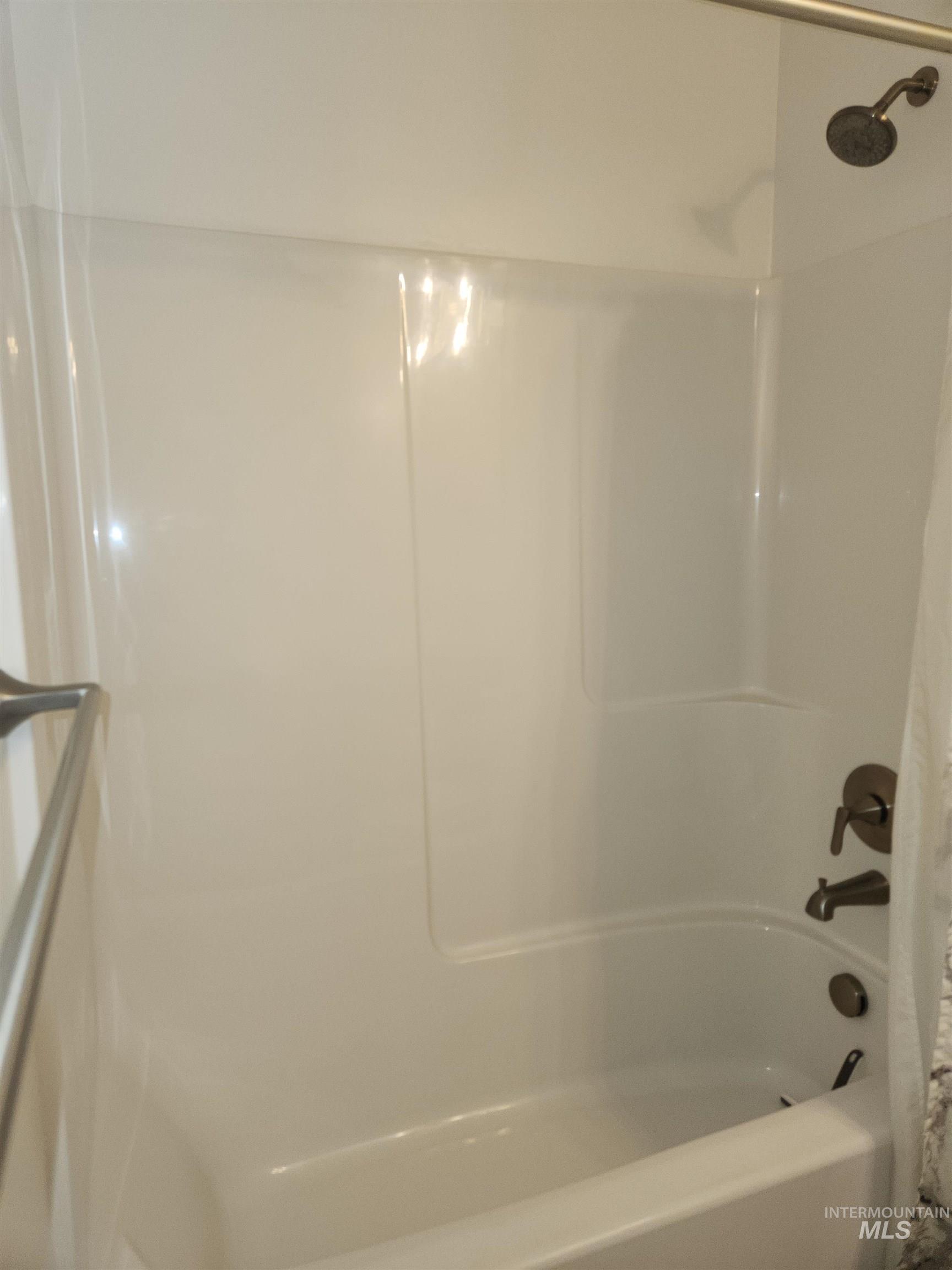 Full bath featuring shower / bath combo