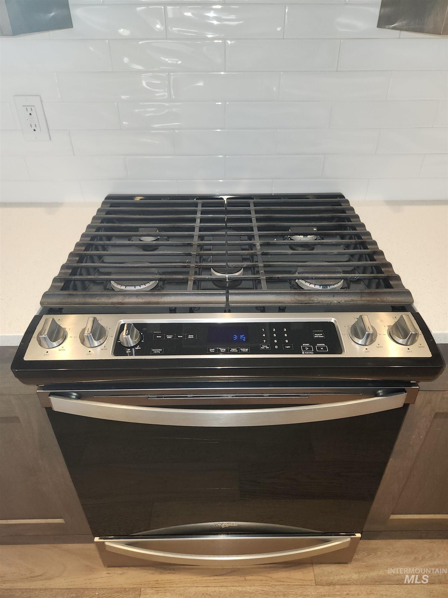 Kitchen view of stainless steel range with gas cooktop