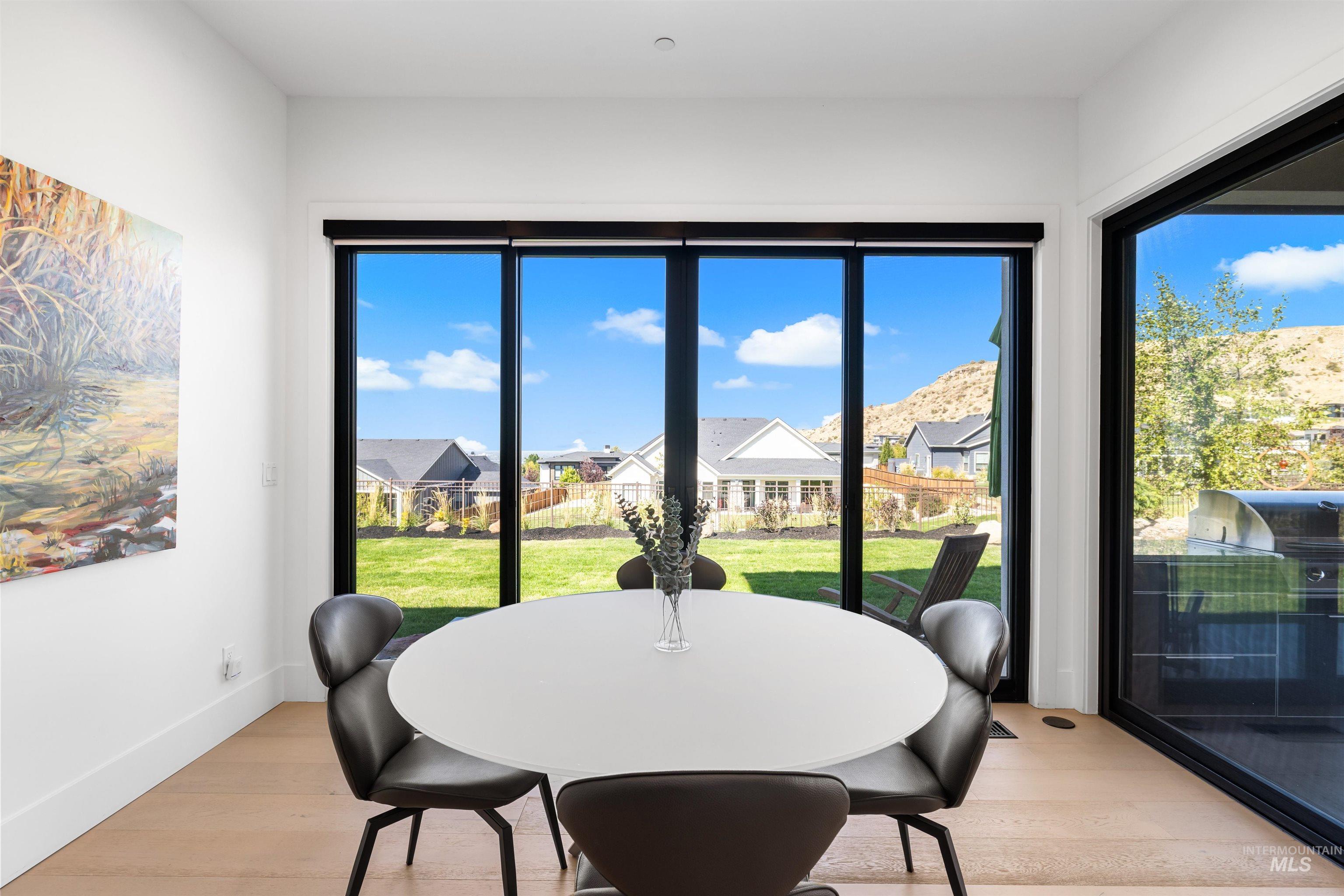 Dining area with a residential view and light wood finished floors