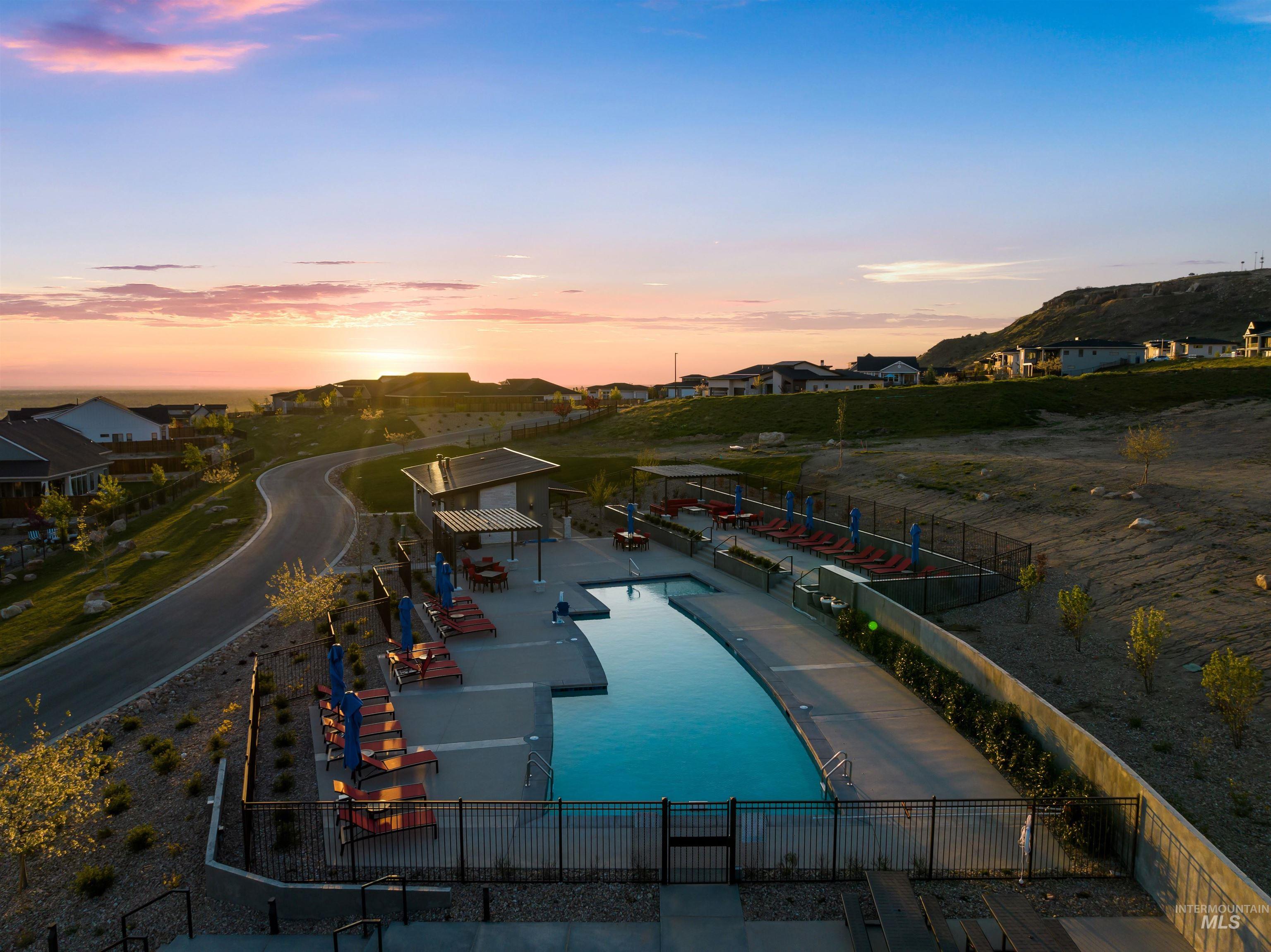 Community pool with a residential view and a patio area