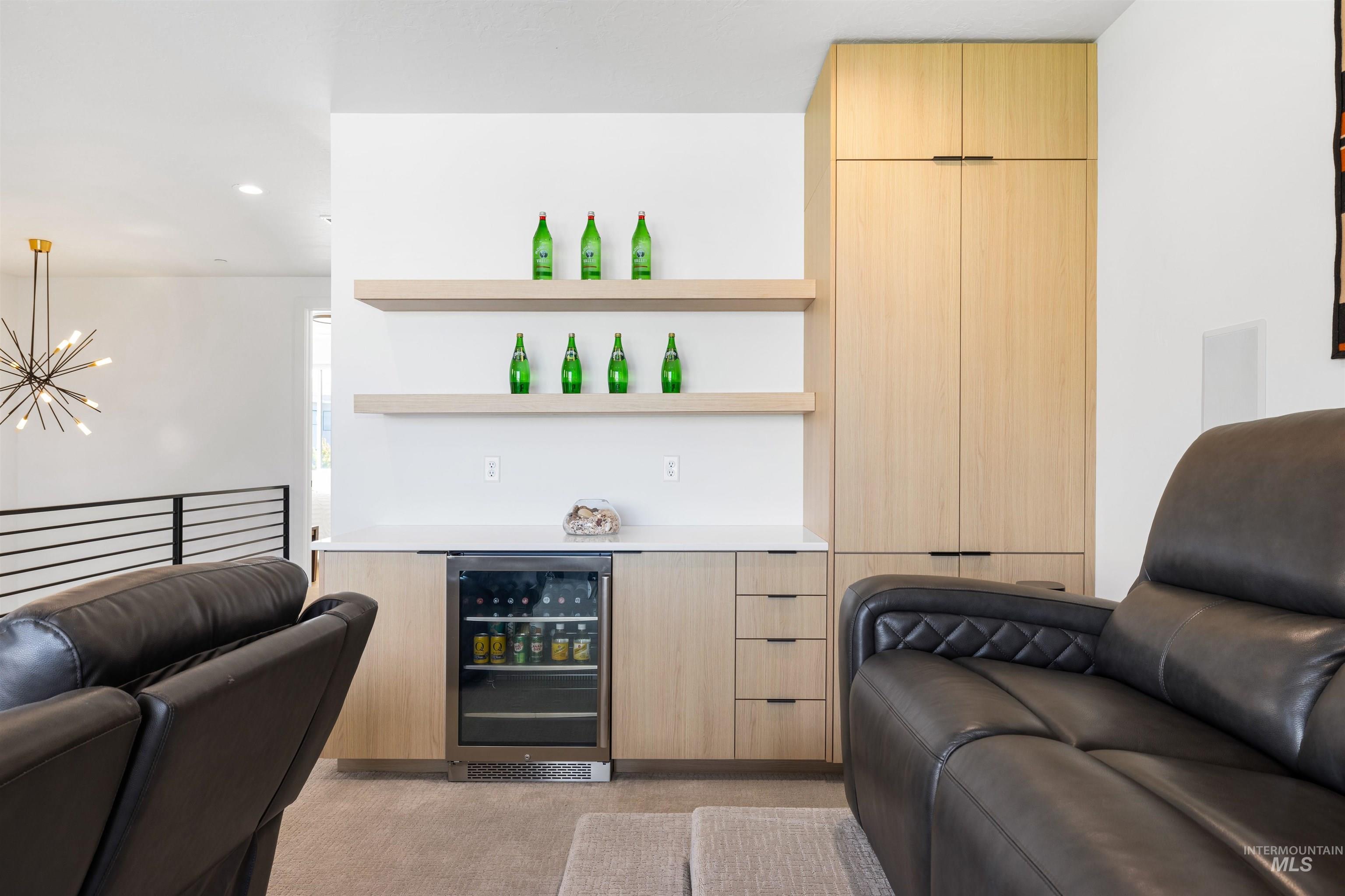 Bar area with open shelves, modern cabinets, light brown cabinetry, wine cooler, and light colored carpet