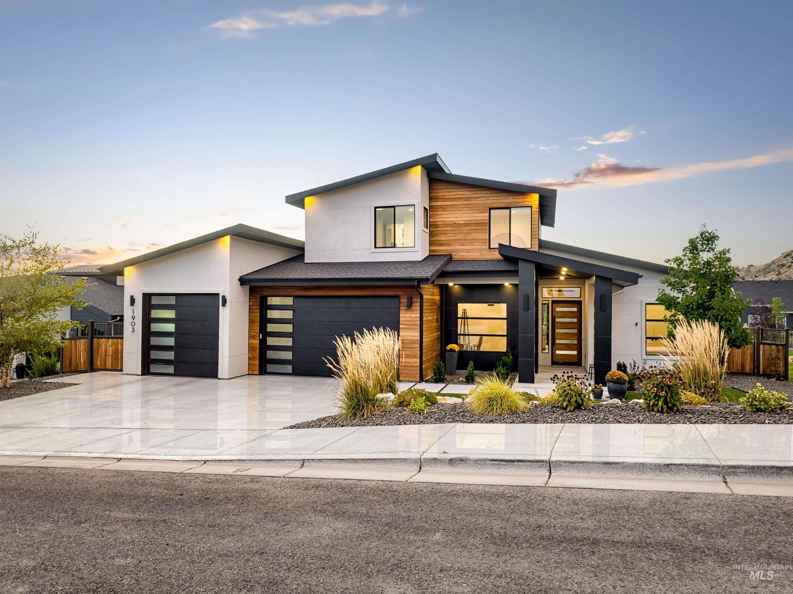 Modern home featuring concrete driveway and stucco siding