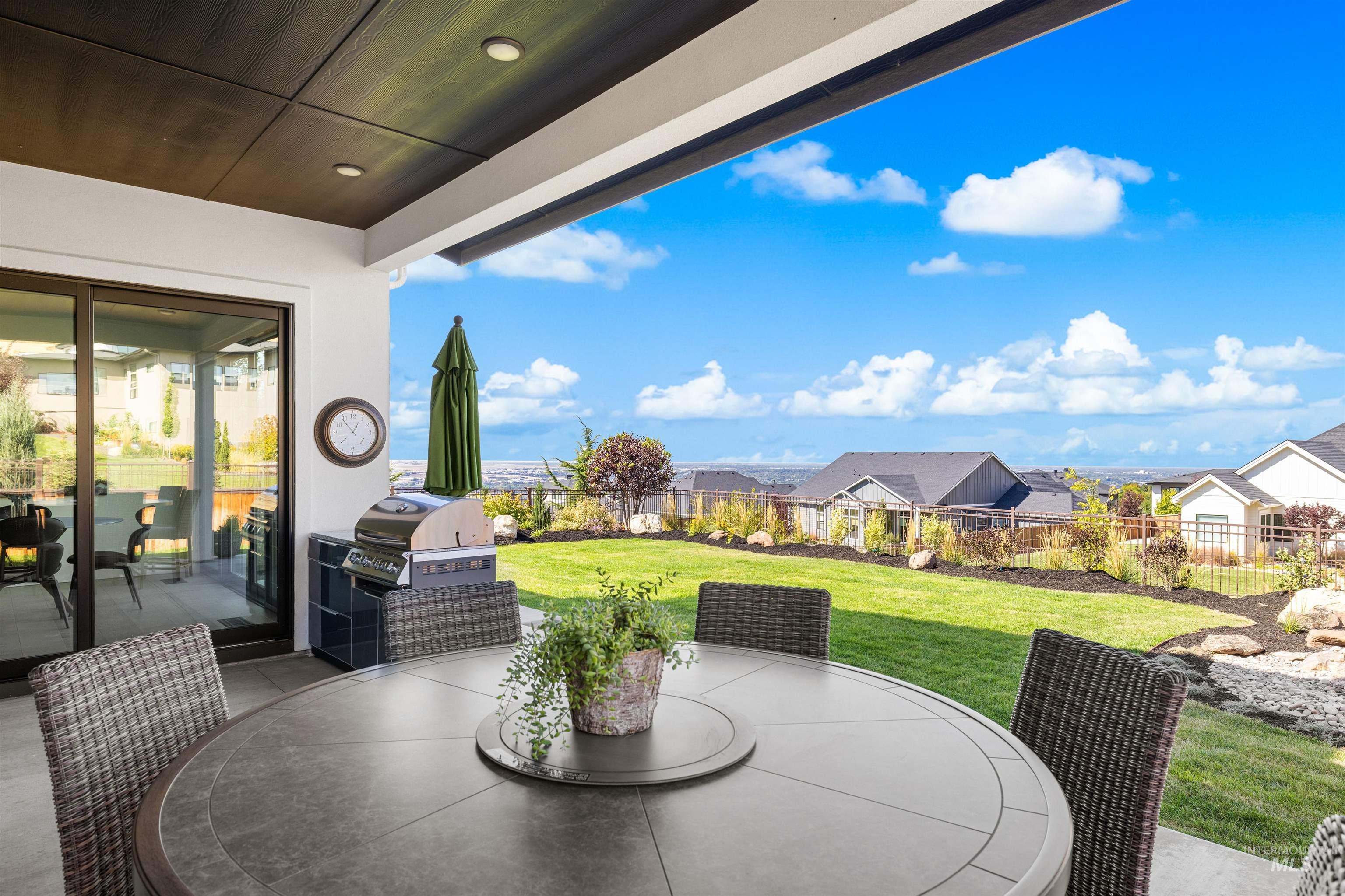 Fenced backyard with outdoor dining area, a patio, area for grilling, and a residential view