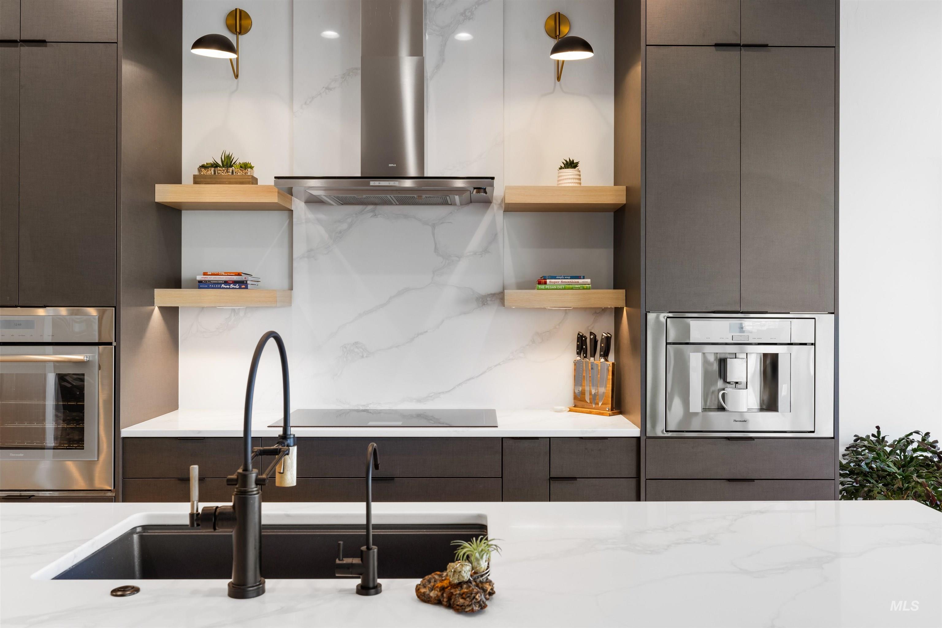 Kitchen featuring modern cabinets, wall chimney exhaust hood, stainless steel oven, and open shelves