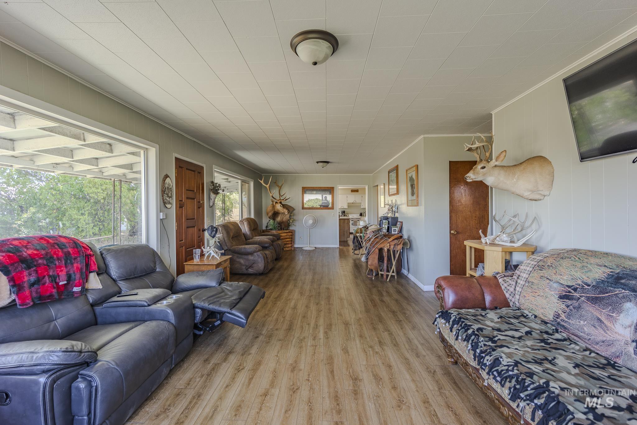 Living area featuring wood finished floors and crown molding