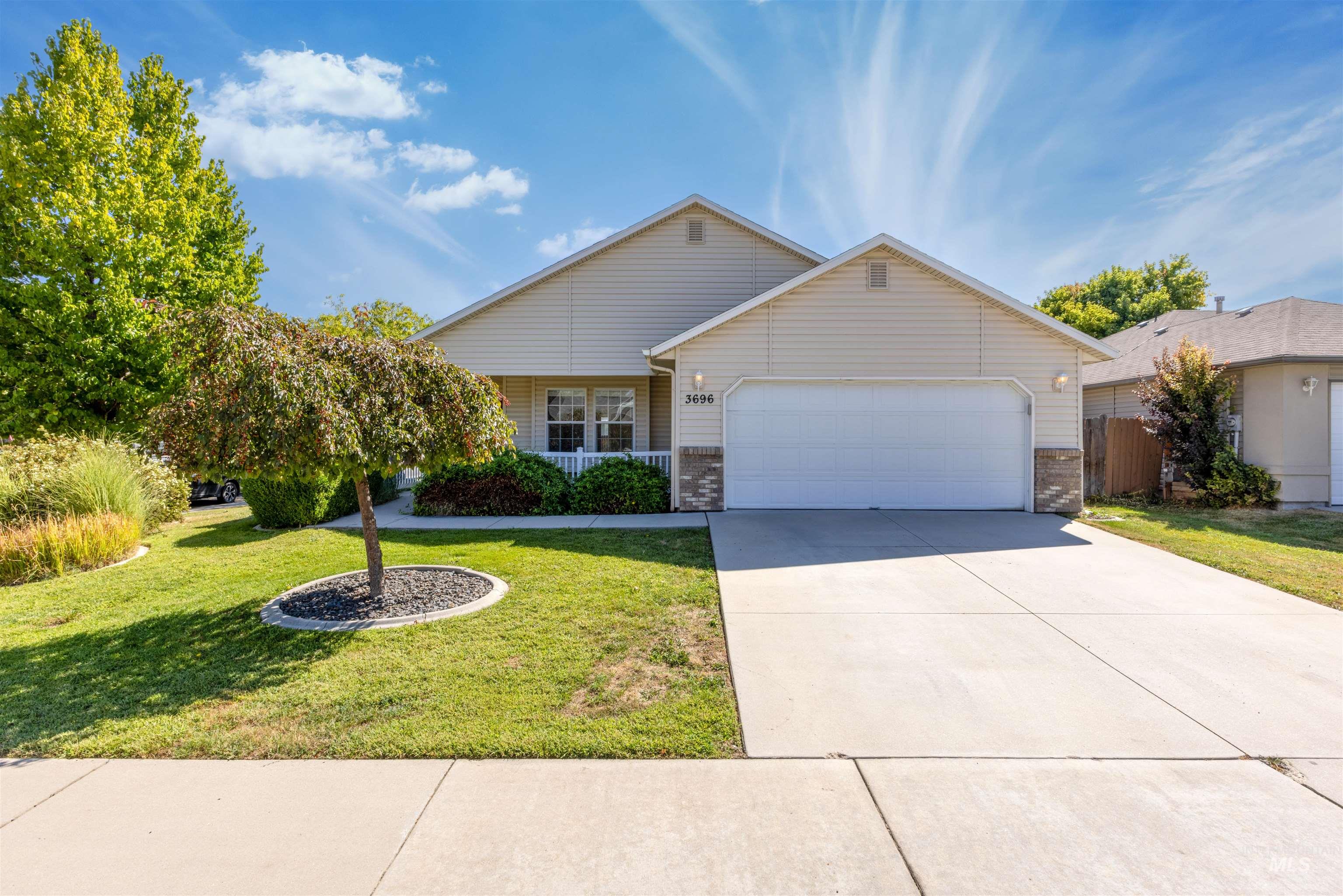 Ranch-style house with a garage, concrete driveway, and brick siding