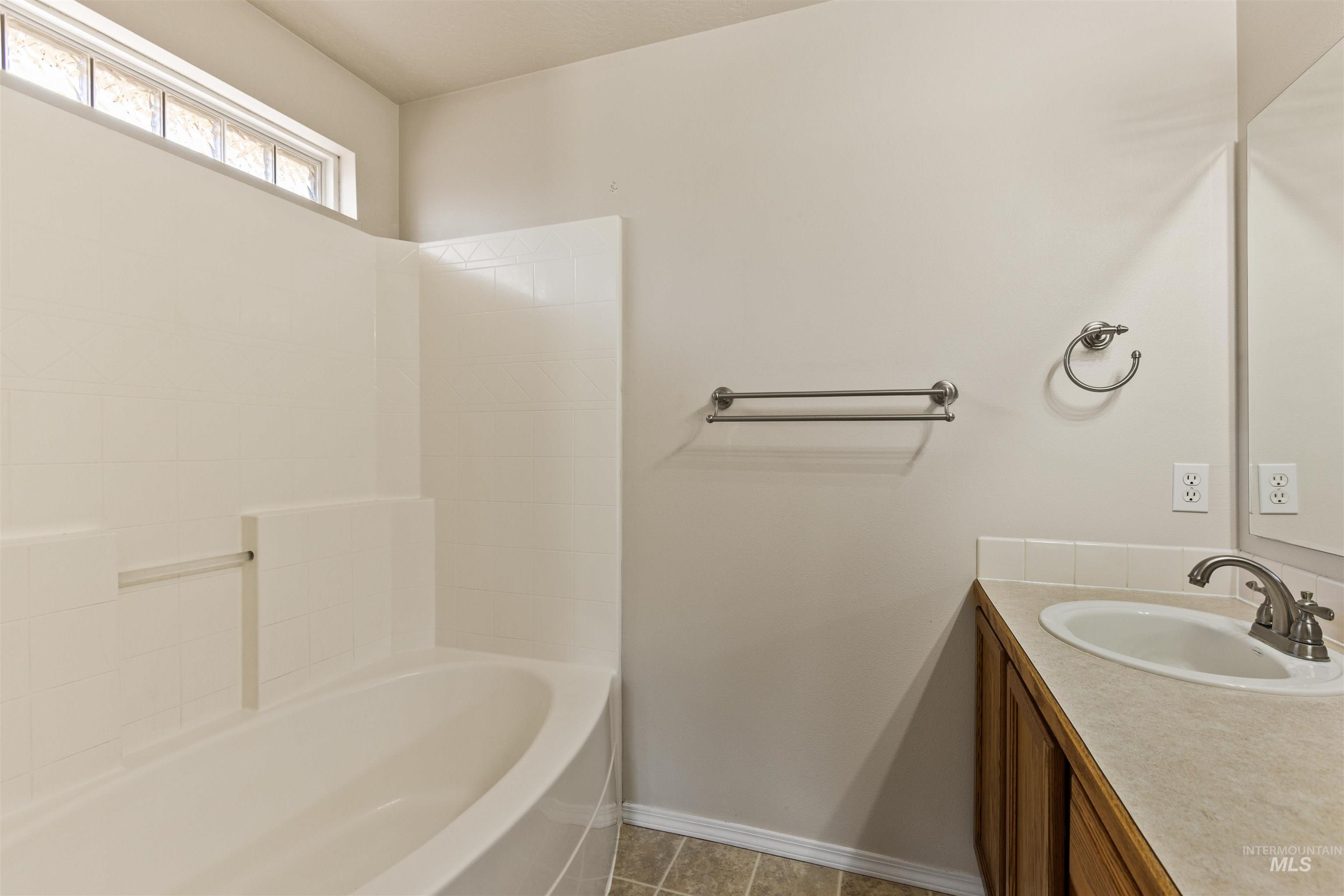 Bathroom featuring vanity and light tile patterned flooring