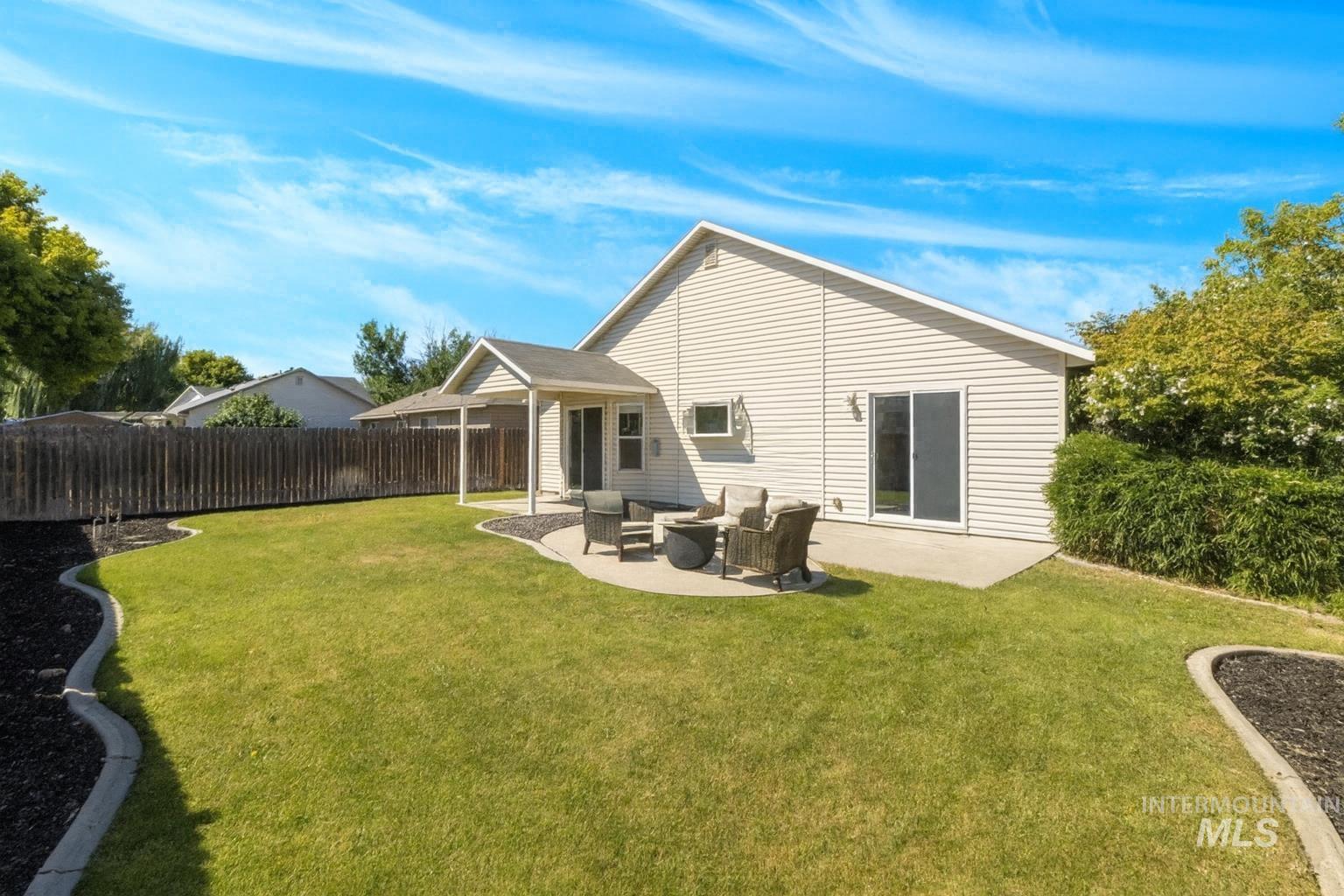 Back of property with a patio area, an outdoor living space, and a fenced backyard