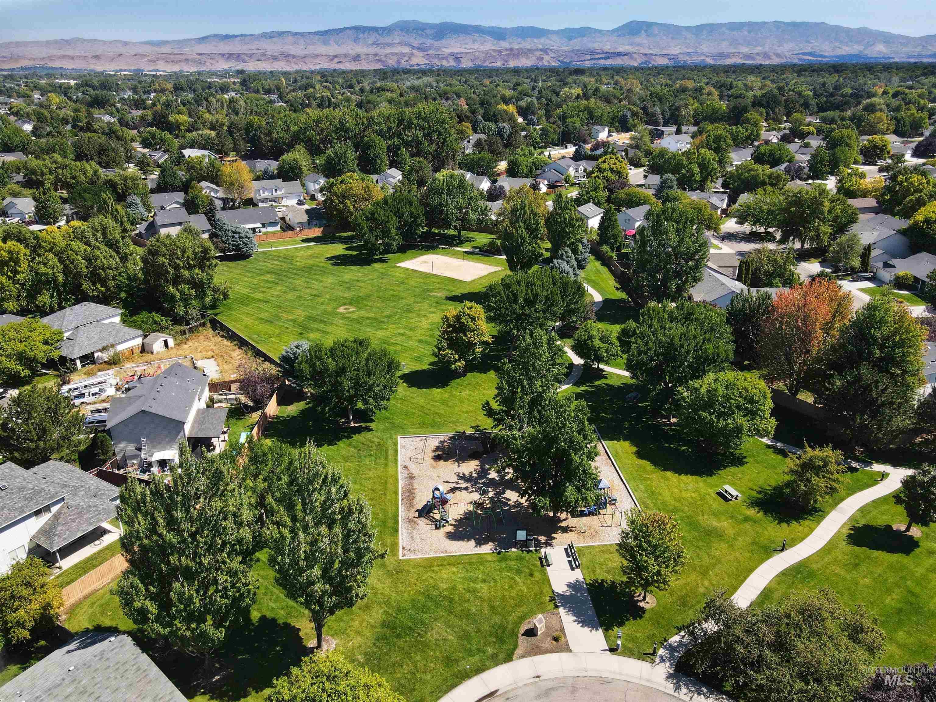 Aerial perspective of suburban area featuring a mountainous background