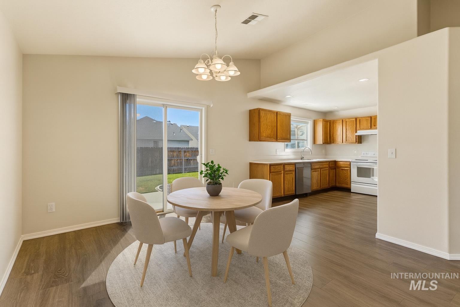 Dining room featuring a chandelier and dark wood-style floors