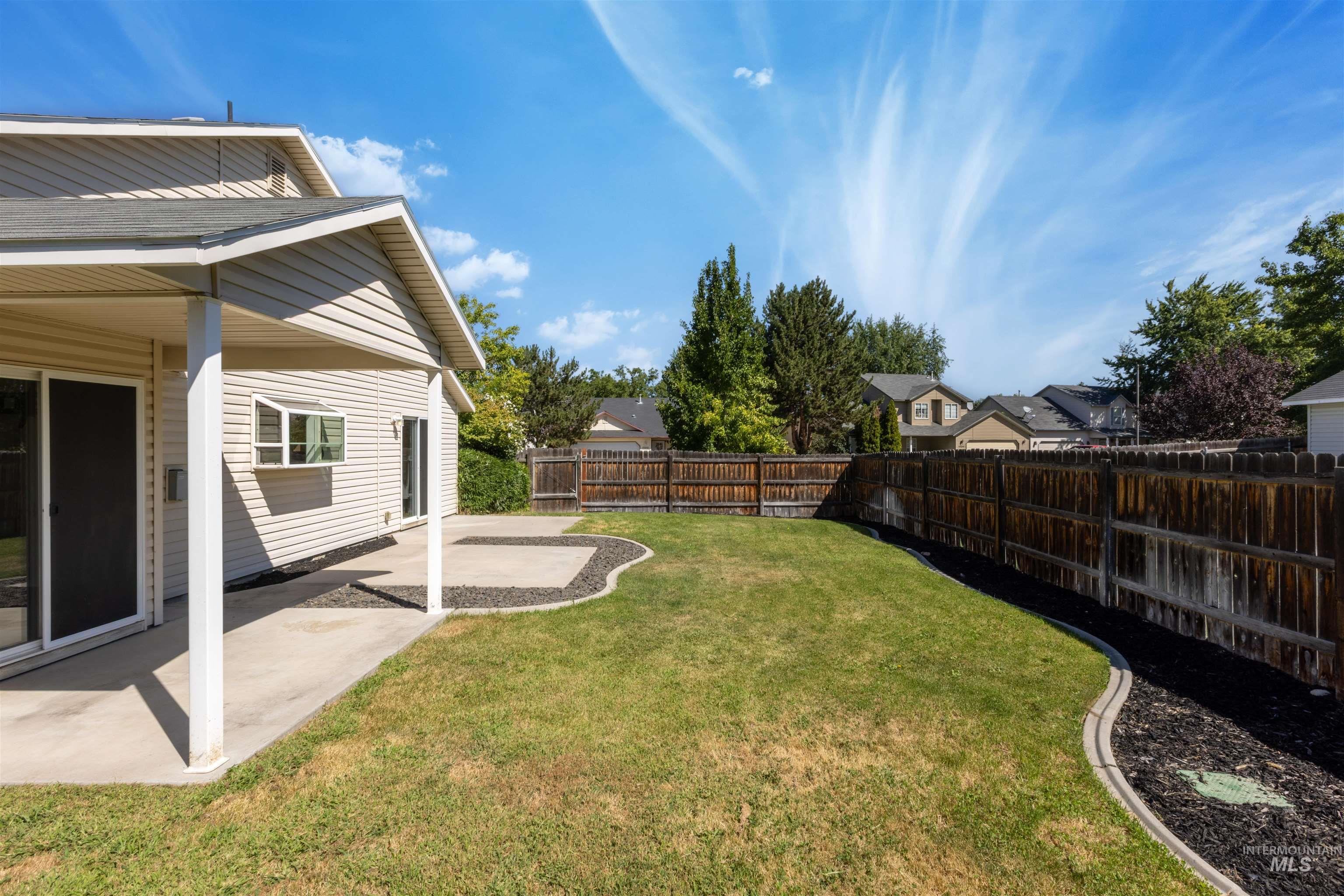 Fenced backyard with a patio