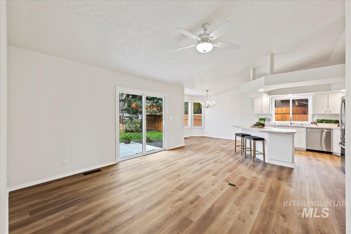 Vaulted Great Room NEW slider door to back patio, LVP flooring, Ceiling fan w/Light - Freshly Painted!