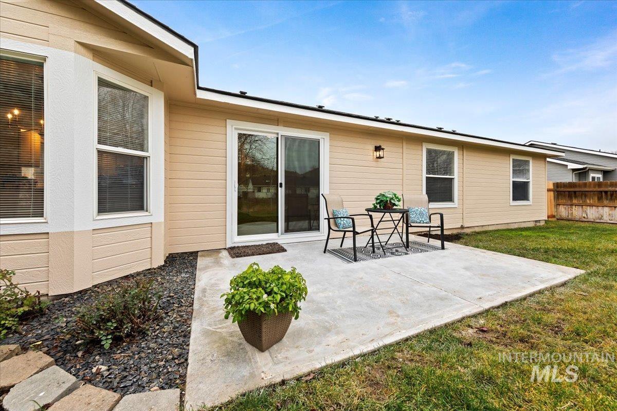 North Facing Rear view of house with a concrete patio - has a filtered view of the Boise Foothills!