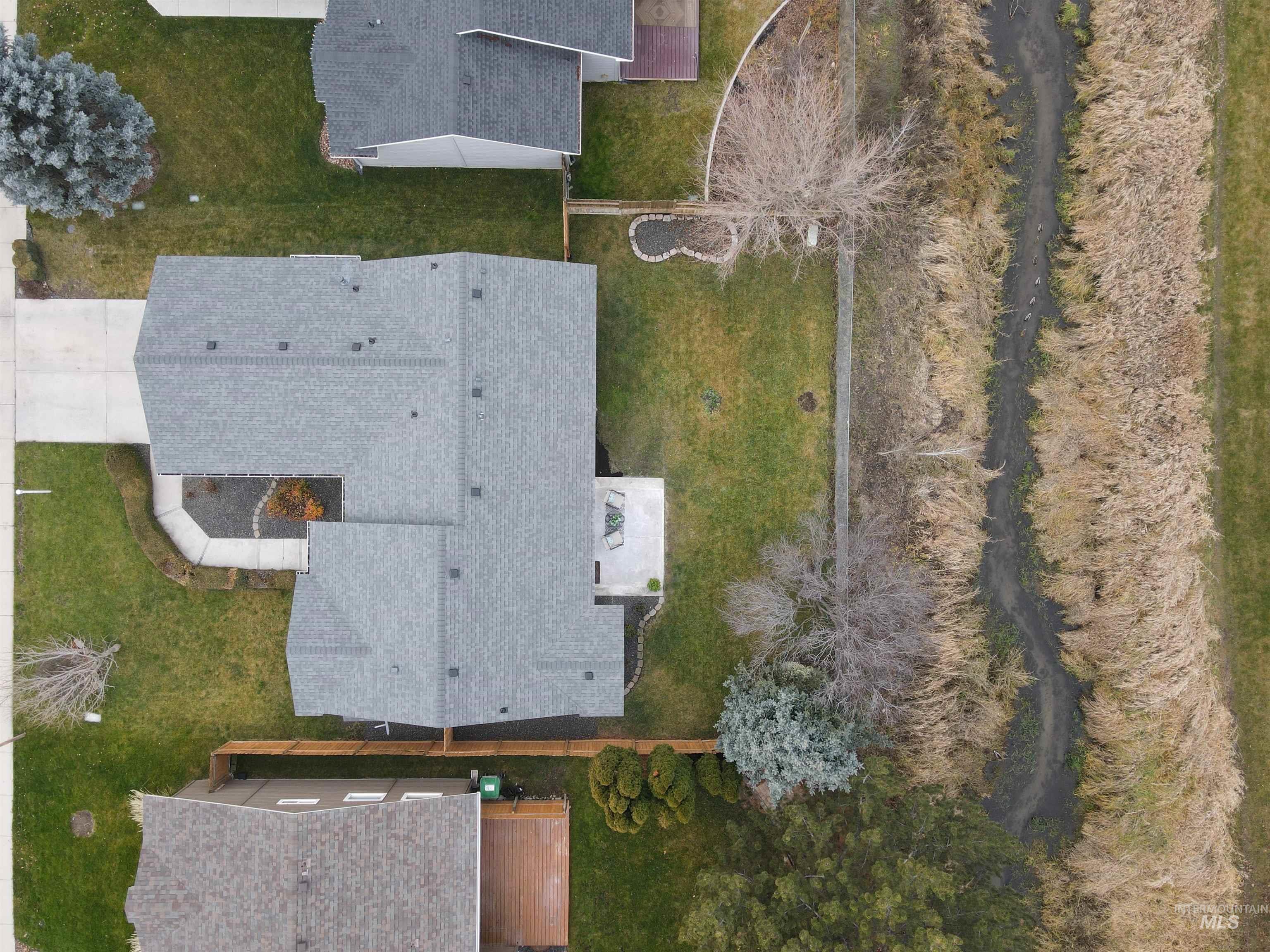 View from above of property showing proximity to seasonal stream and open space behind the property to the North