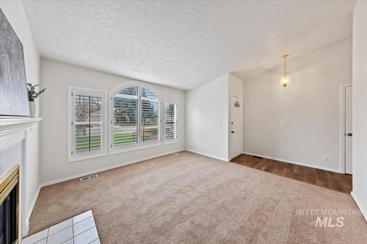 Fresh Interior Paint throughout in September 2025.  New Carpet & Pad, Fireplace - Sunny Inviting front living room!