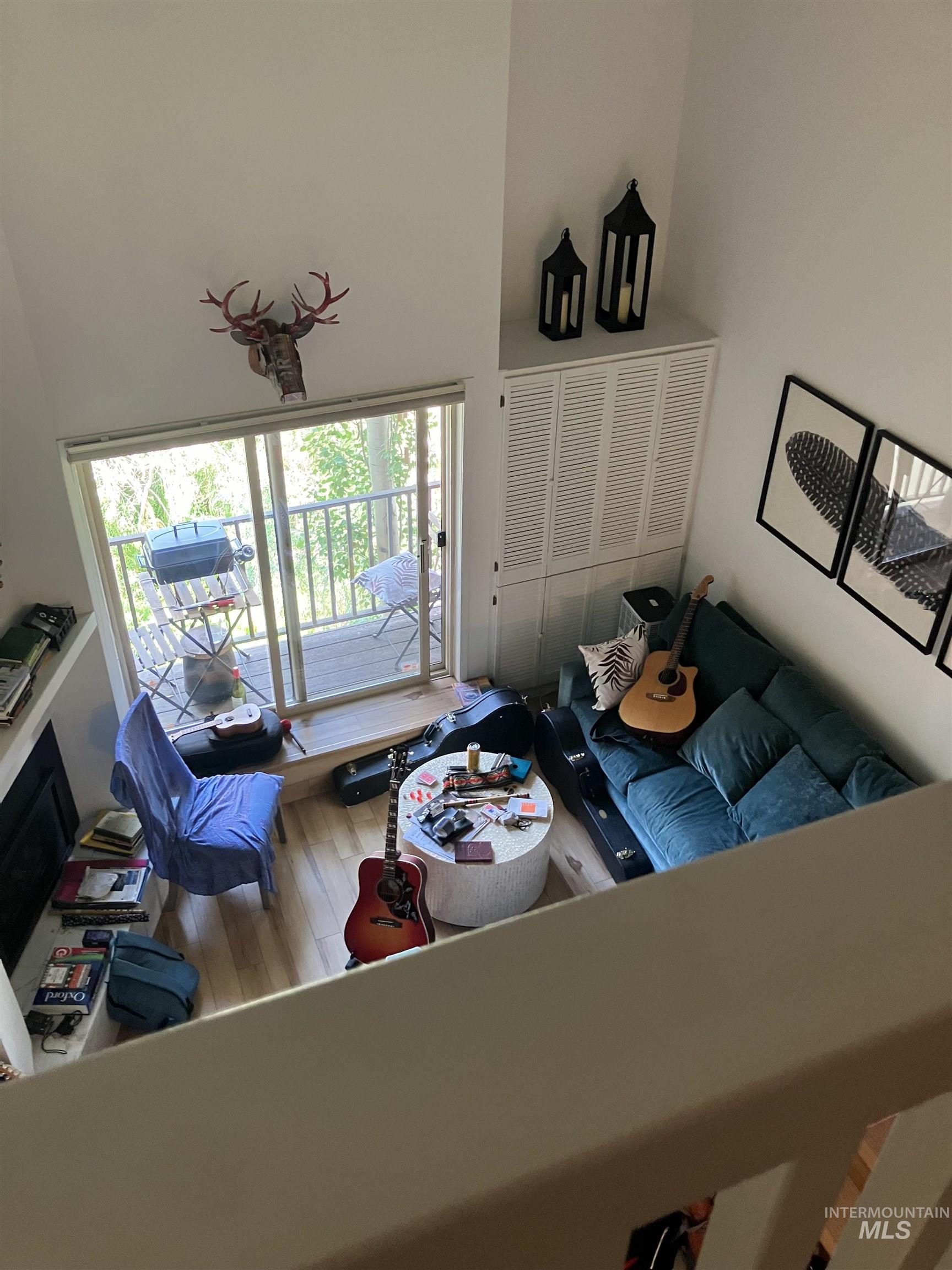 Living area with a vaulted ceiling and wood-finish flooring