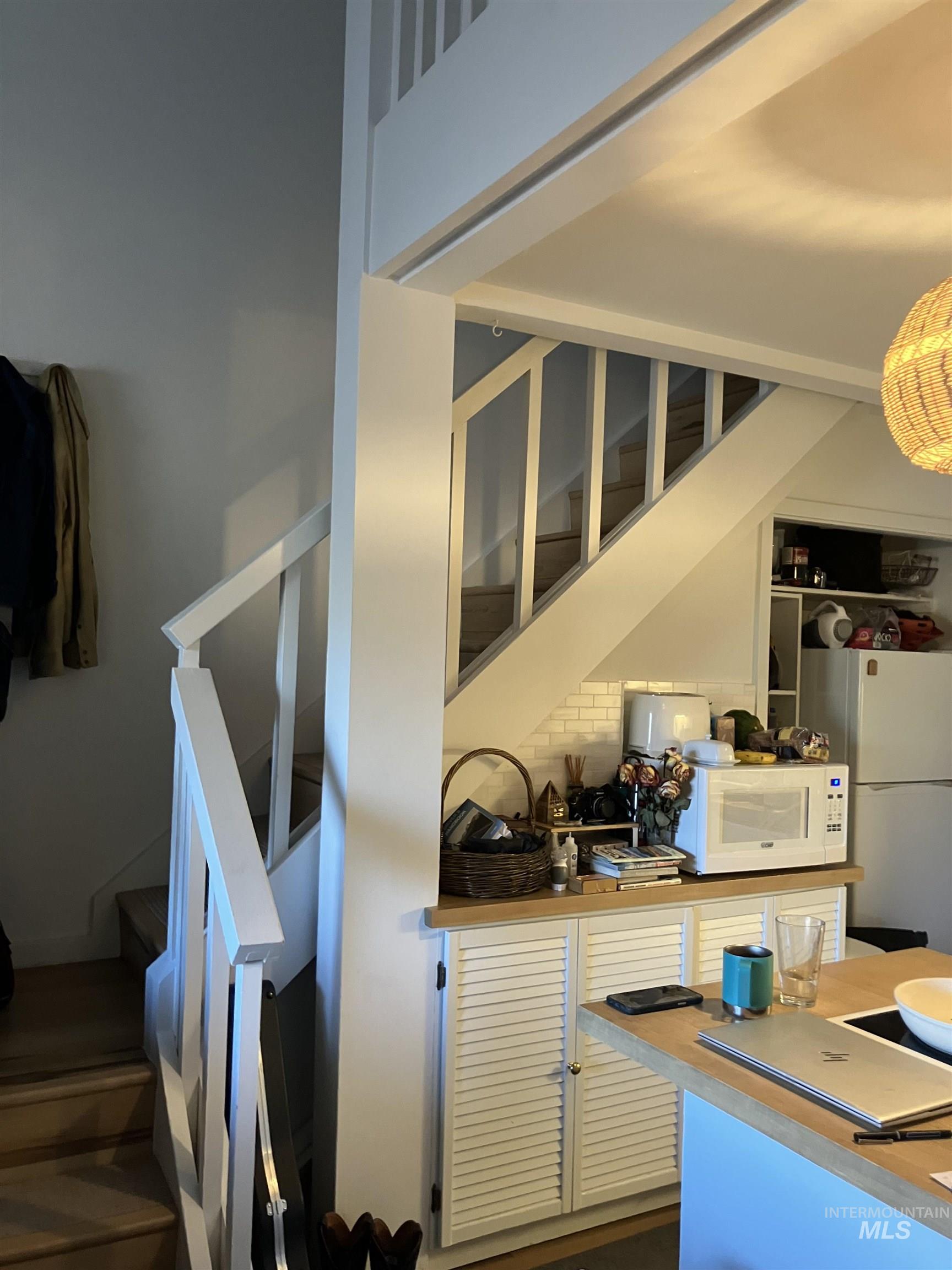 White painted wooden staircase with light wood-finish treads