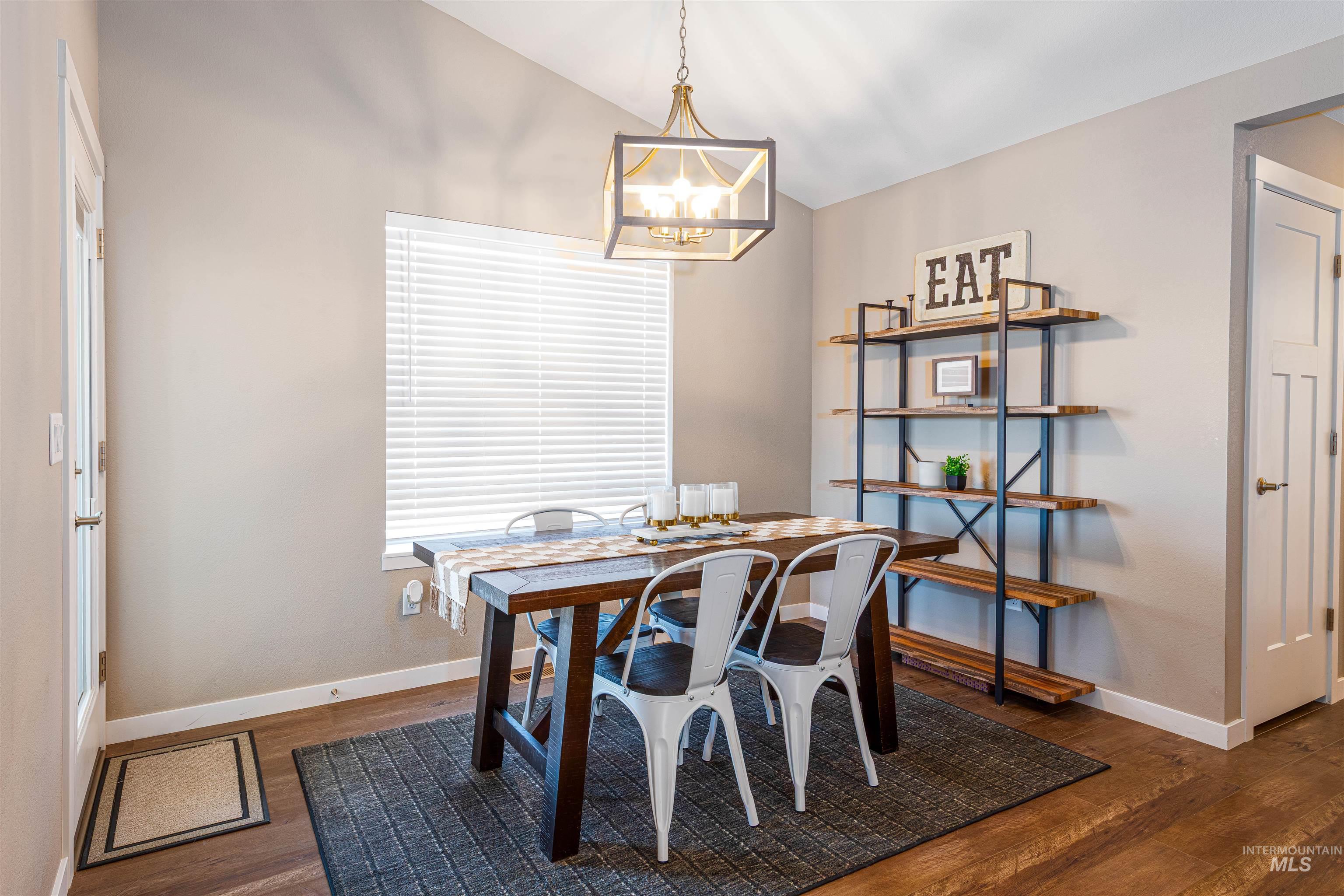 Dining area featuring baseboards and dark wood-style flooring