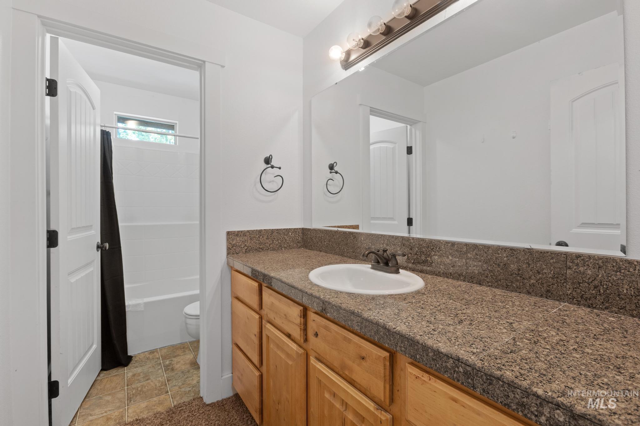 Bathroom with vanity and shower / bath combo