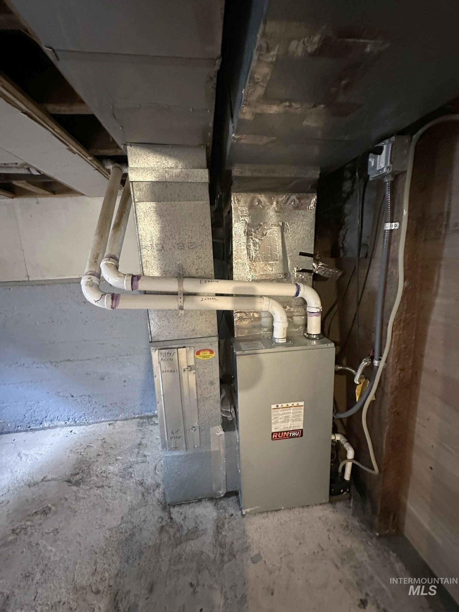 HVAC system featuring a KUNCL furnace, galvanized ductwork, and PVC plumbing lines