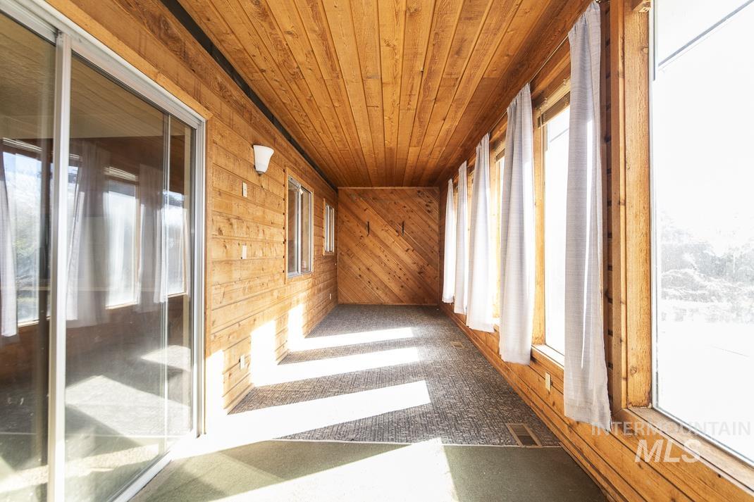 Hall featuring wooden walls and wooden ceiling
