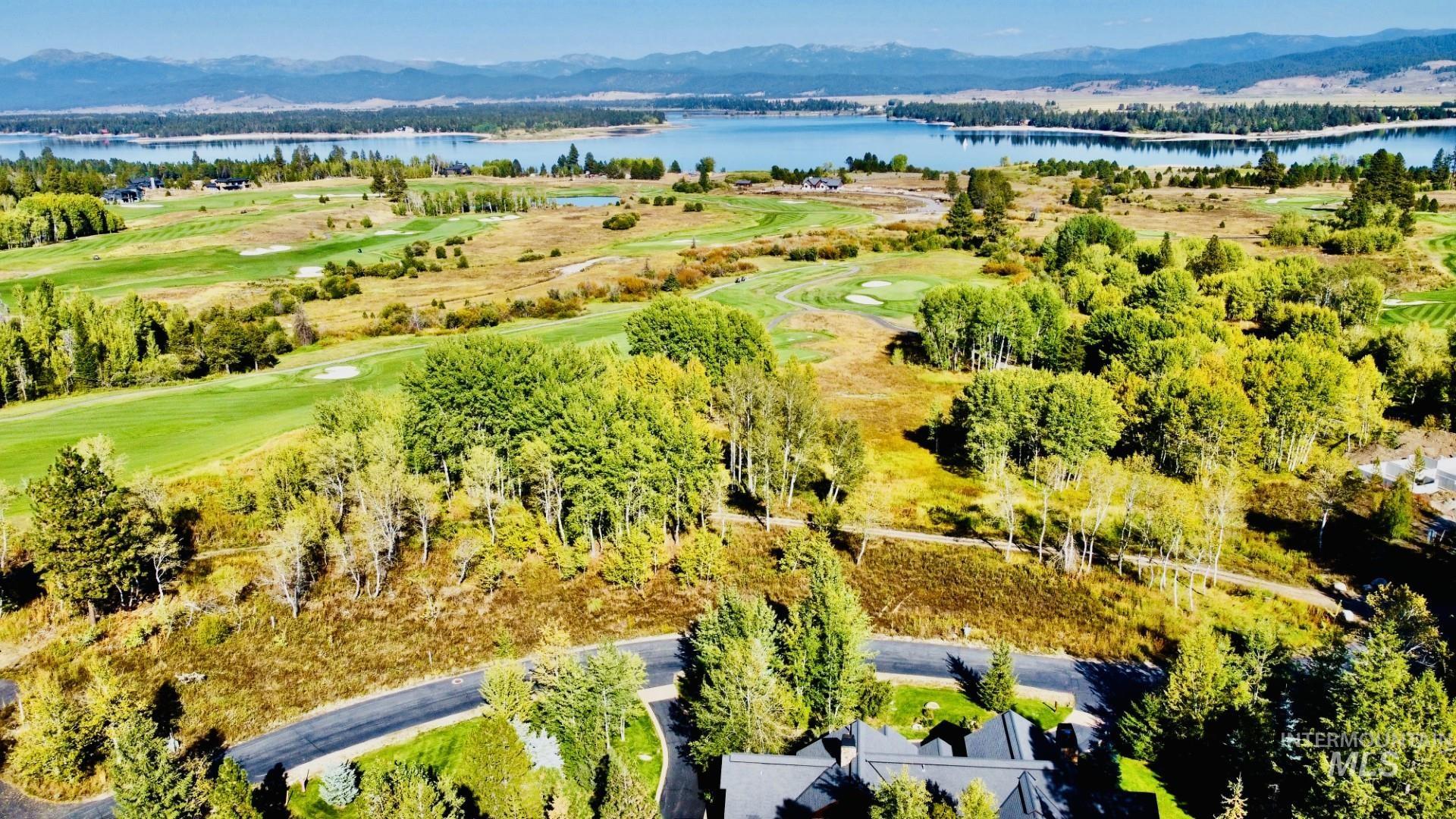 Bird's eye view of a water and mountain view and a golf club