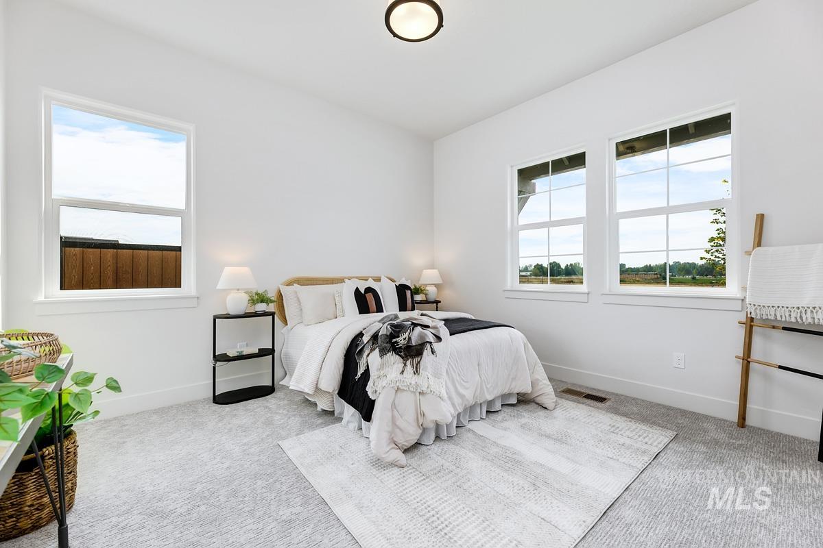 Bedroom with carpet flooring and baseboards