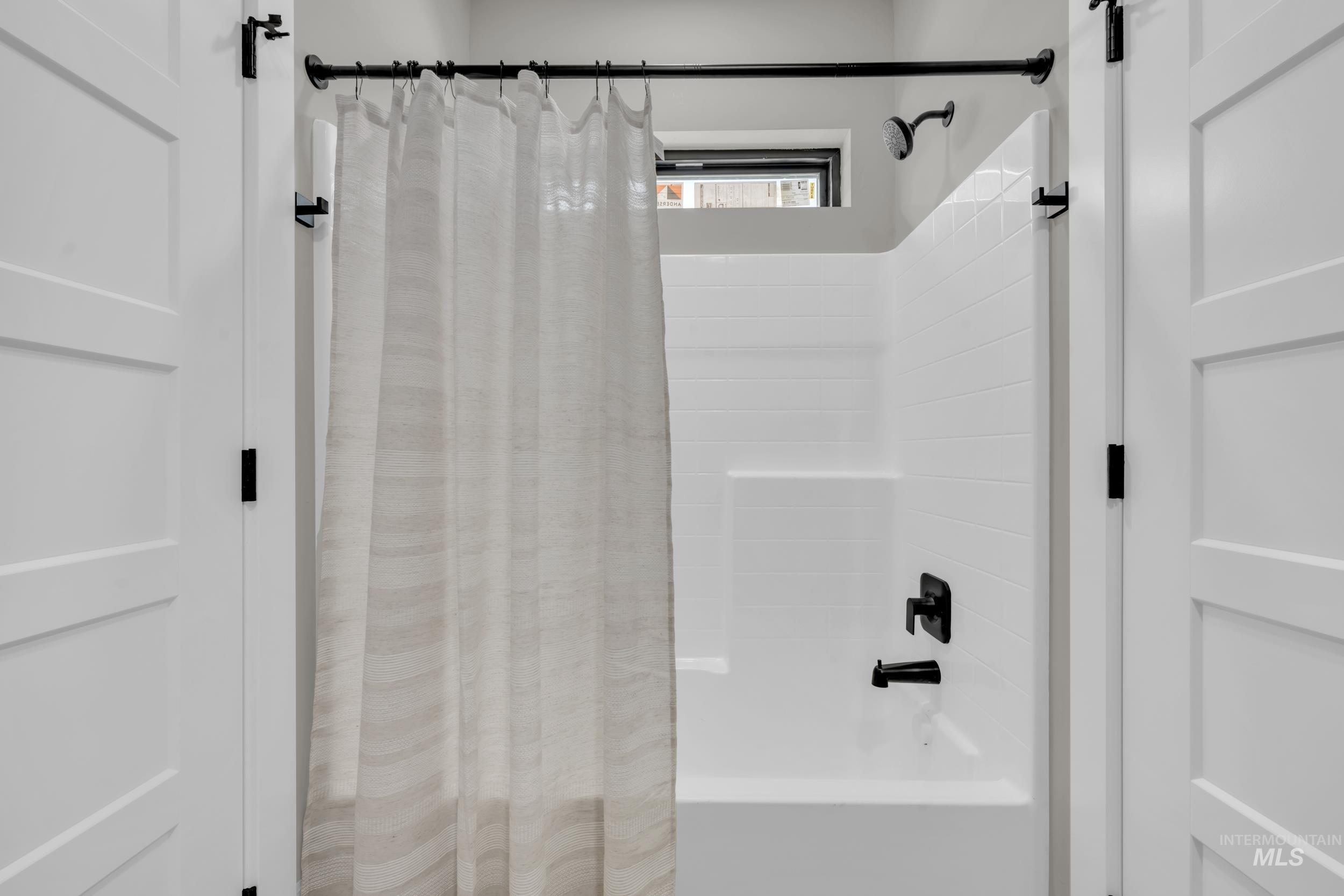 Full bathroom with shower / bath combination with curtain