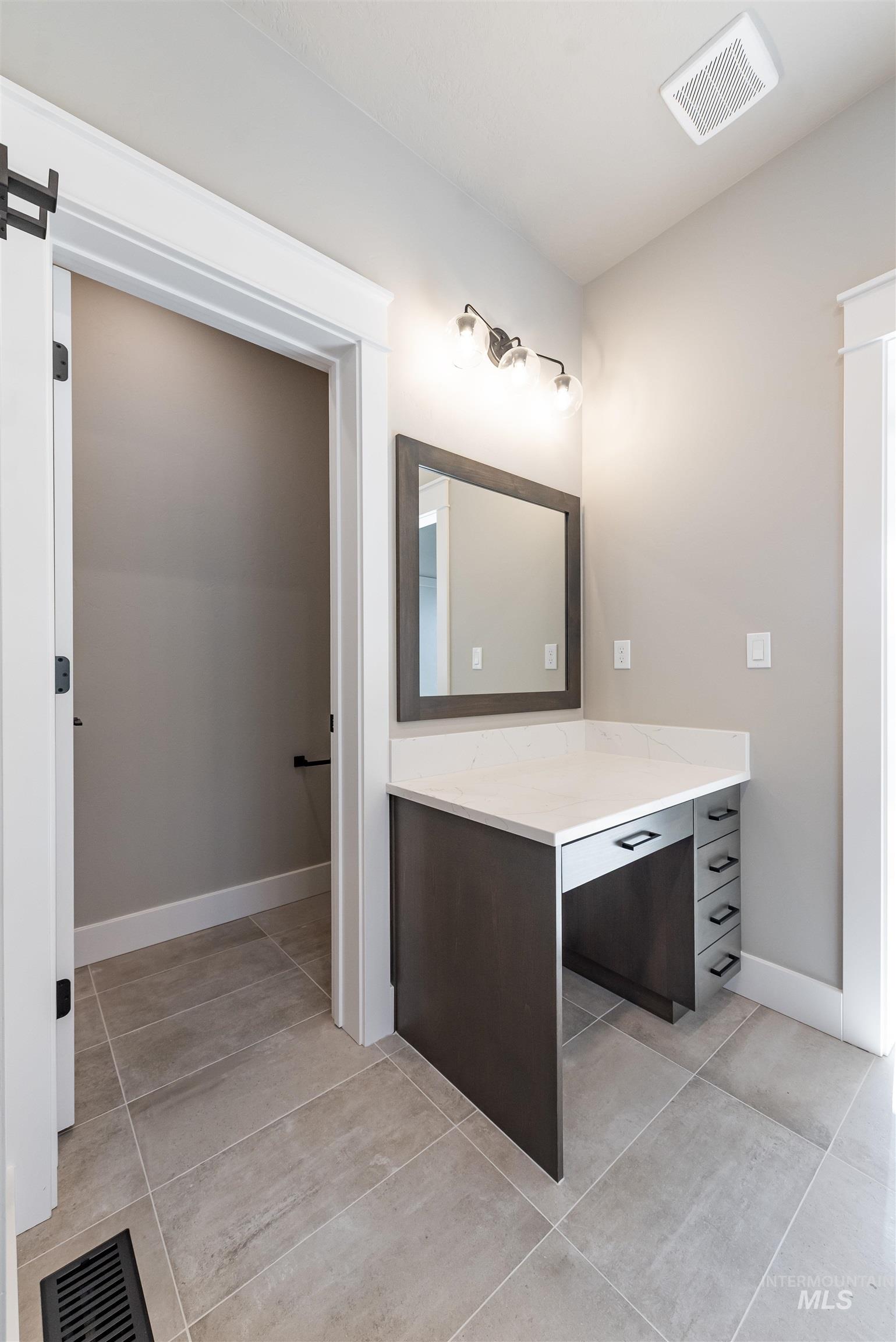 Bathroom featuring vanity and light tile patterned flooring