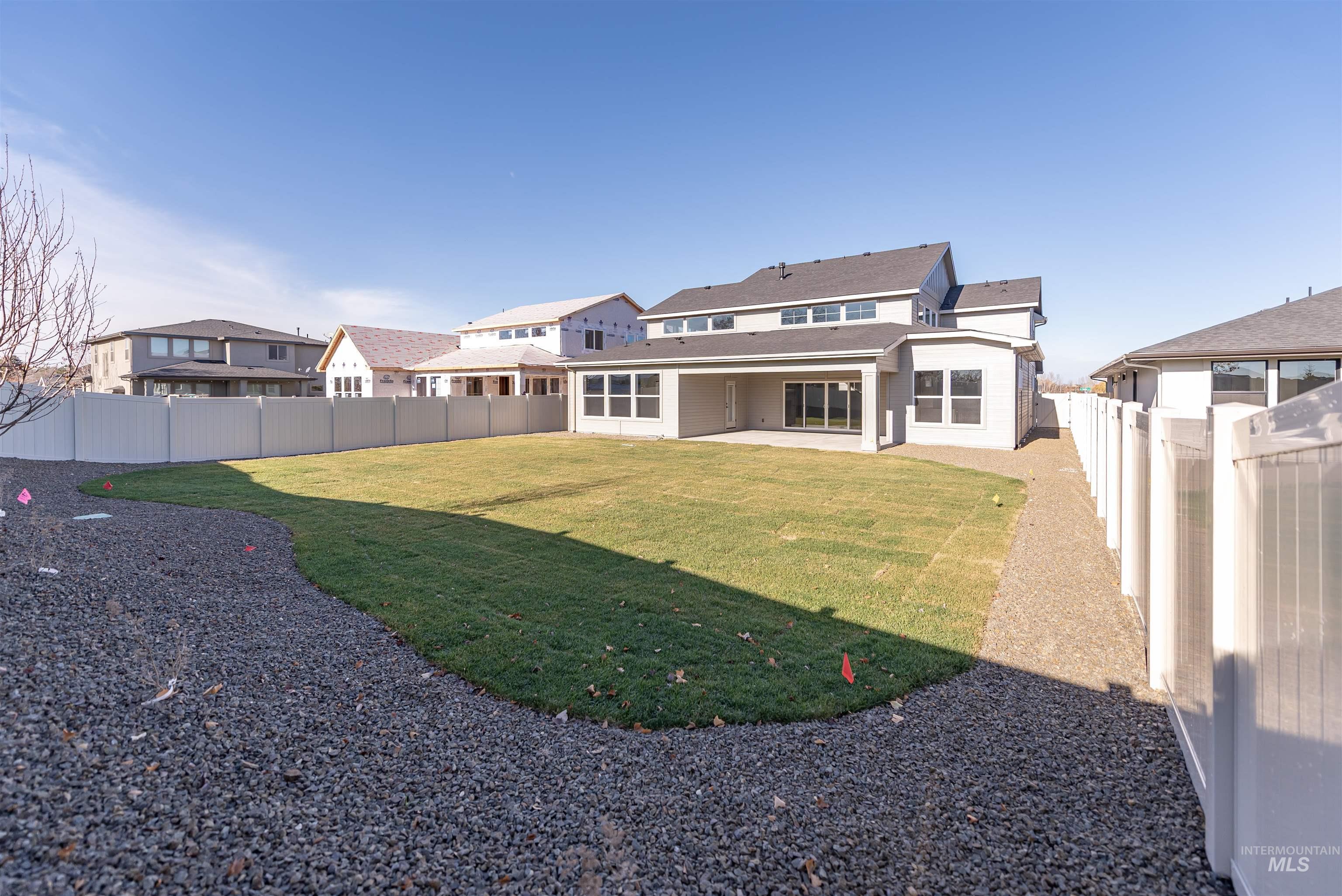 Rear view of property with a patio and a fenced backyard