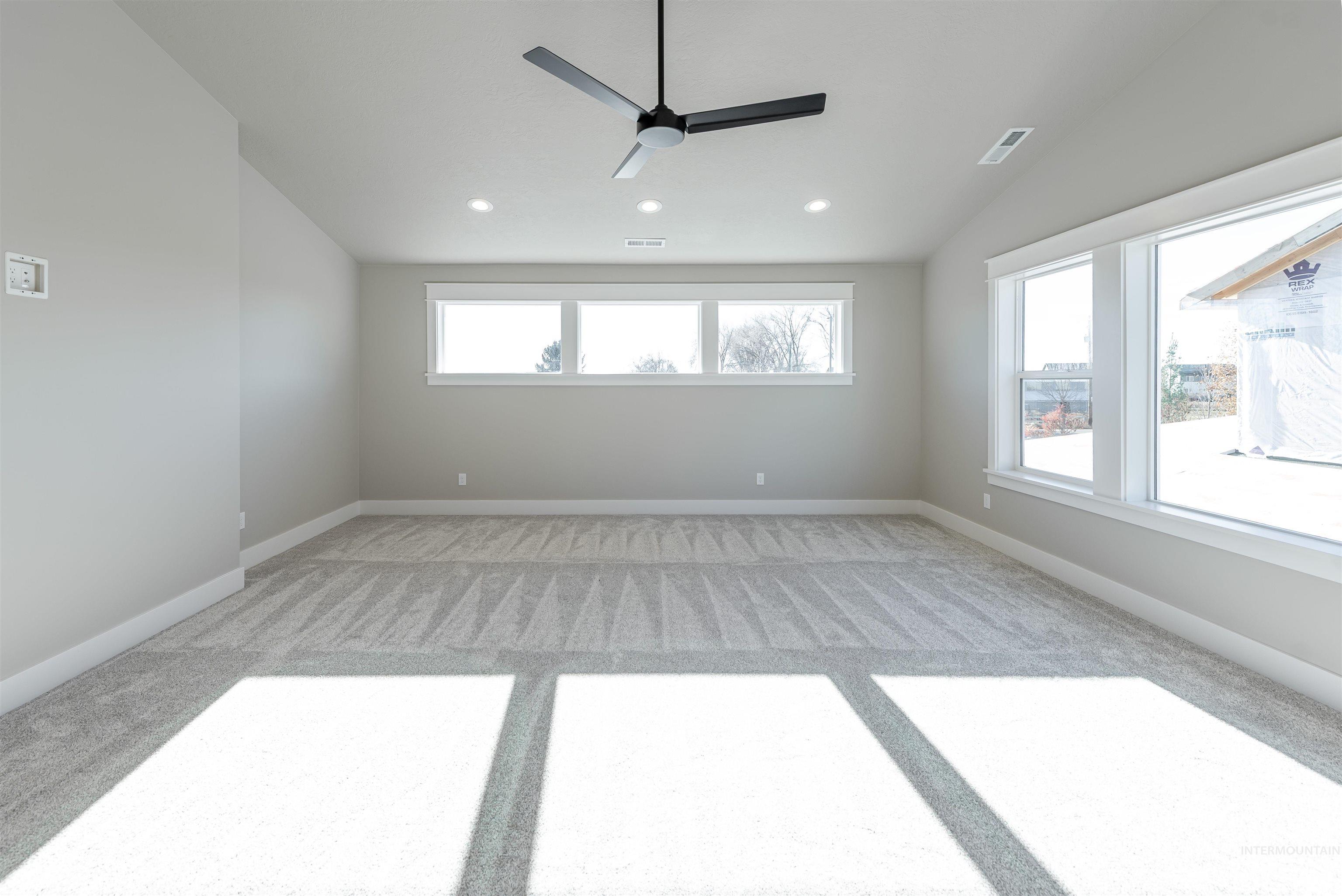 Unfurnished room featuring light carpet, vaulted ceiling, recessed lighting, and a ceiling fan