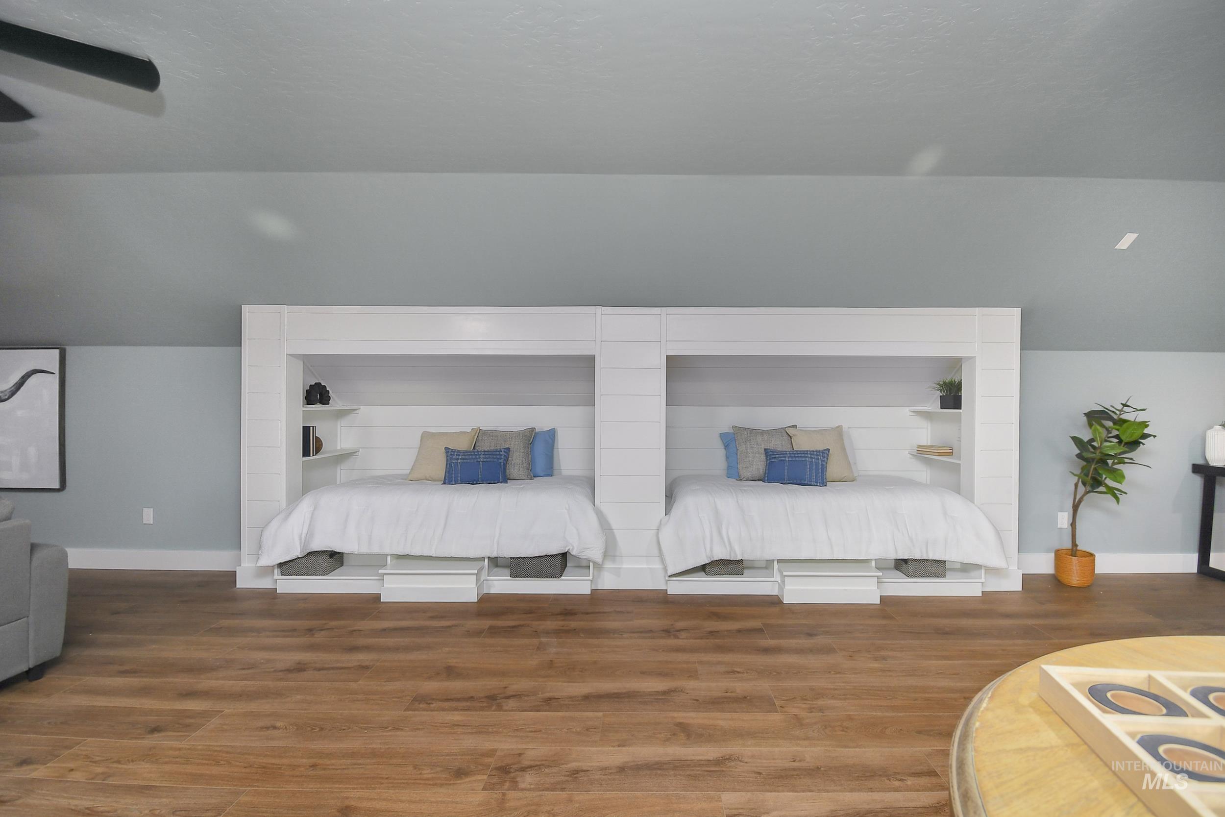 Bedroom with a ceiling fan and wood finished floors
