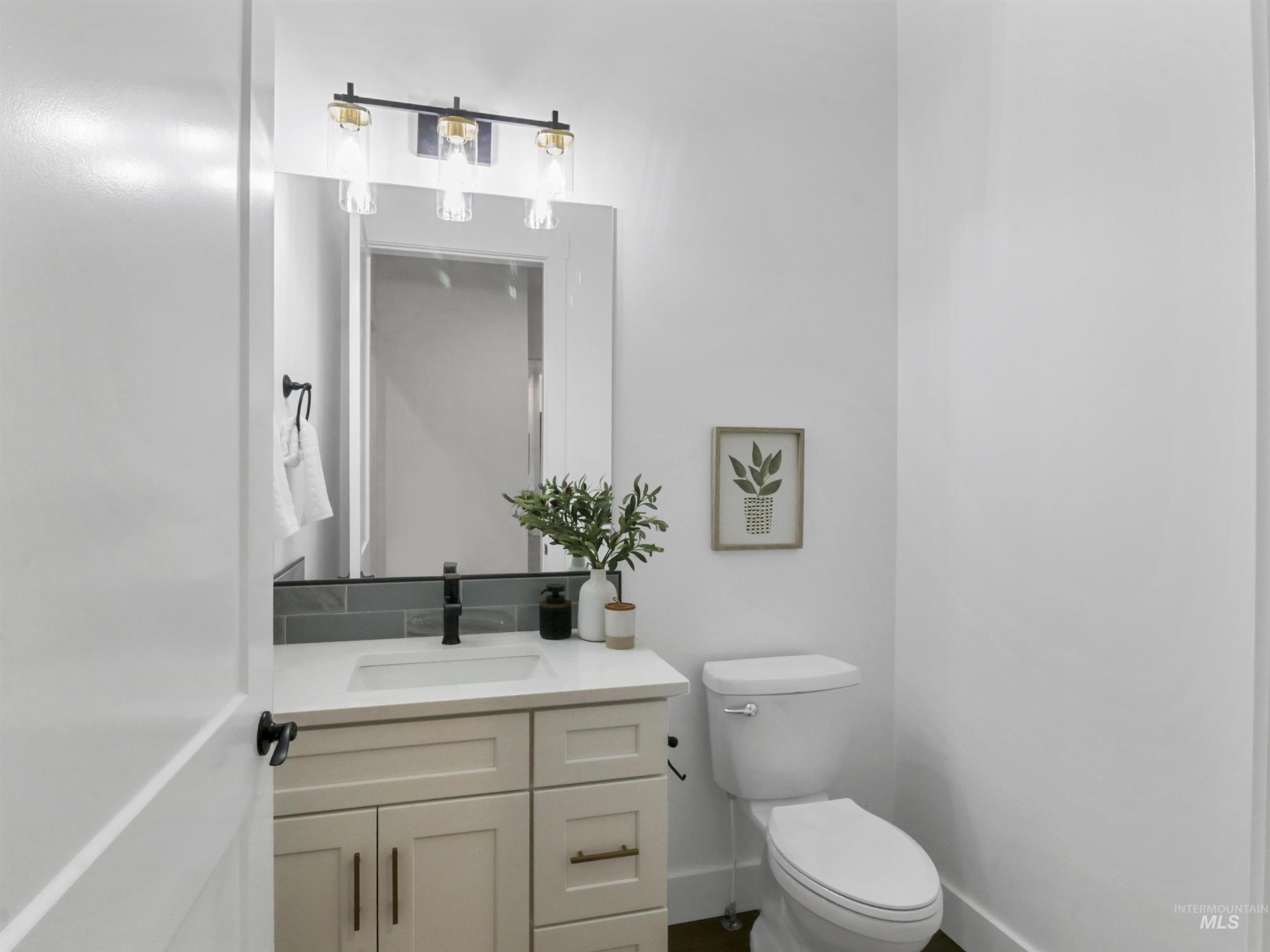 Half bathroom with vanity and toilet