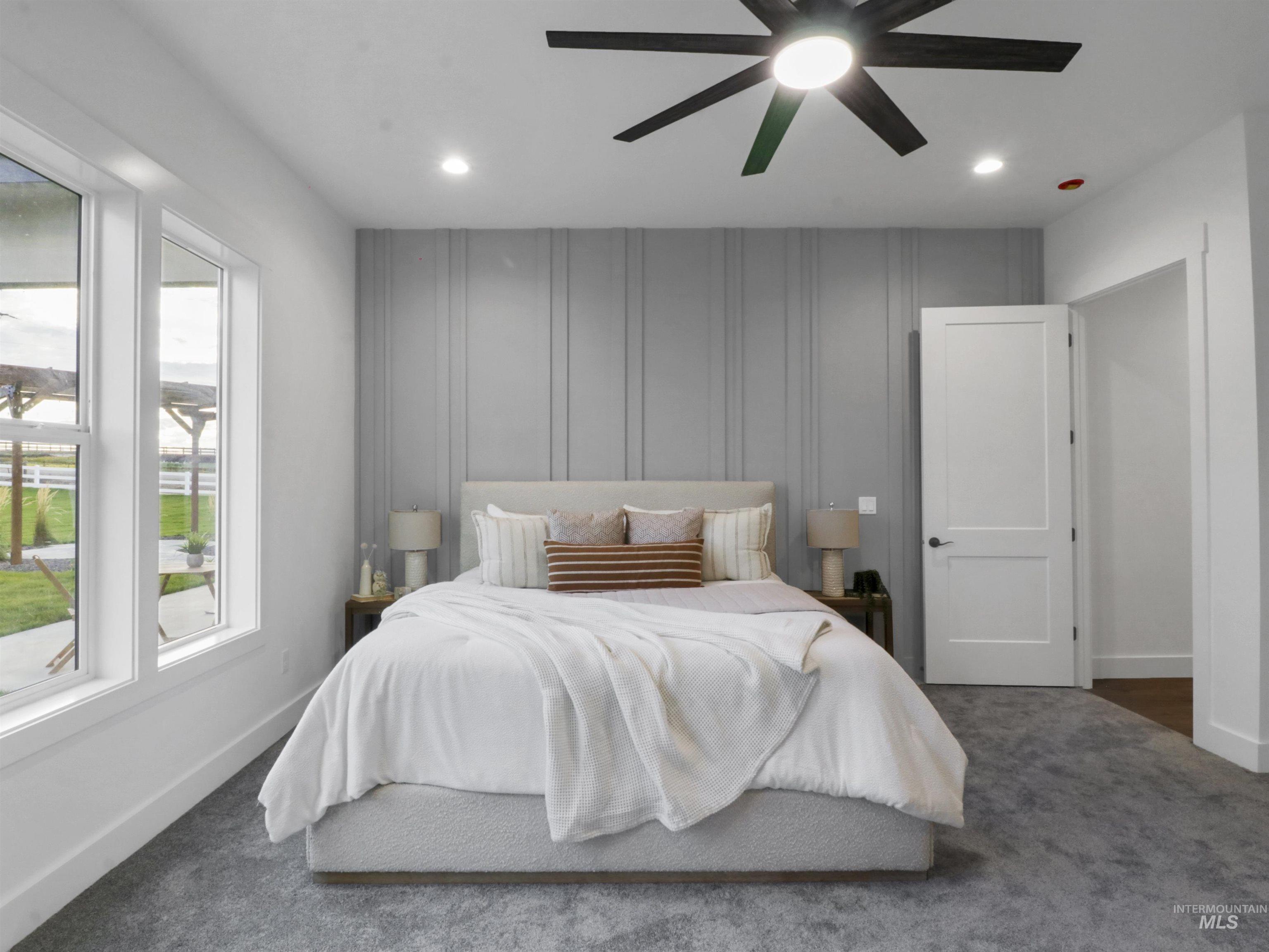Bedroom with dark carpet, recessed lighting, and a ceiling fan