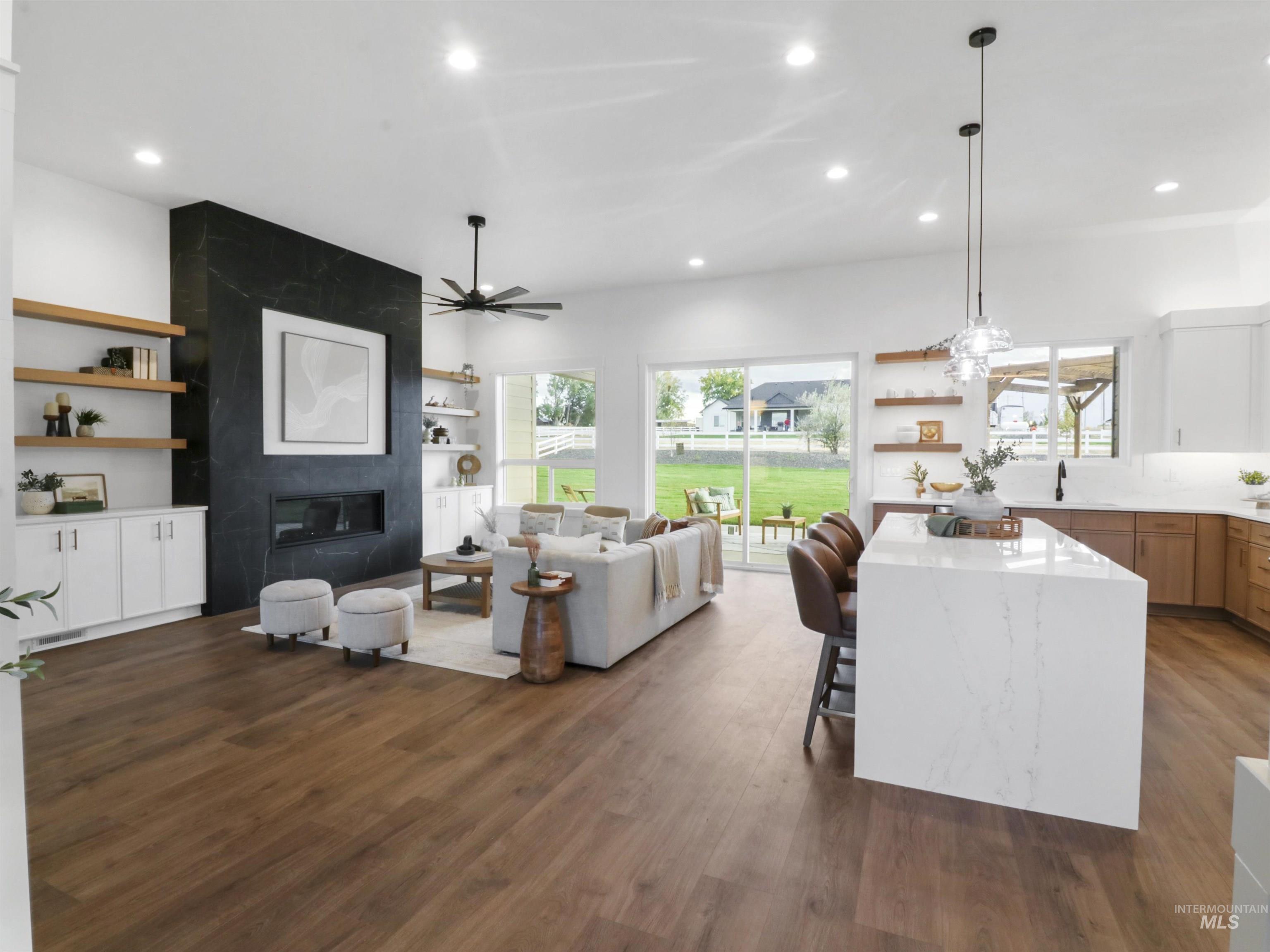 Living room featuring recessed lighting, a fireplace, dark wood-style floors, plenty of natural light, and a ceiling fan