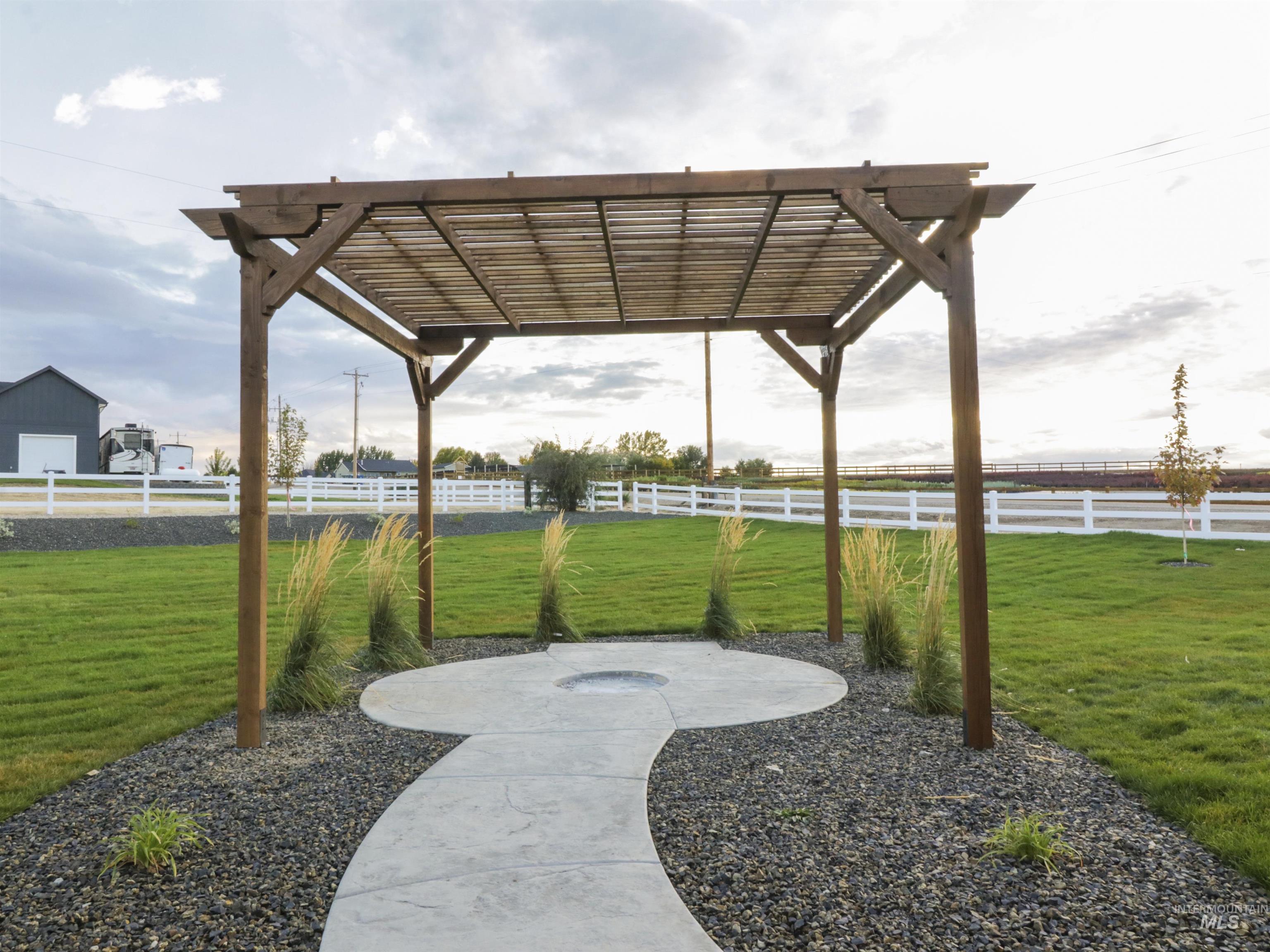 View of property's community with a pergola, a fenced backyard, and a patio