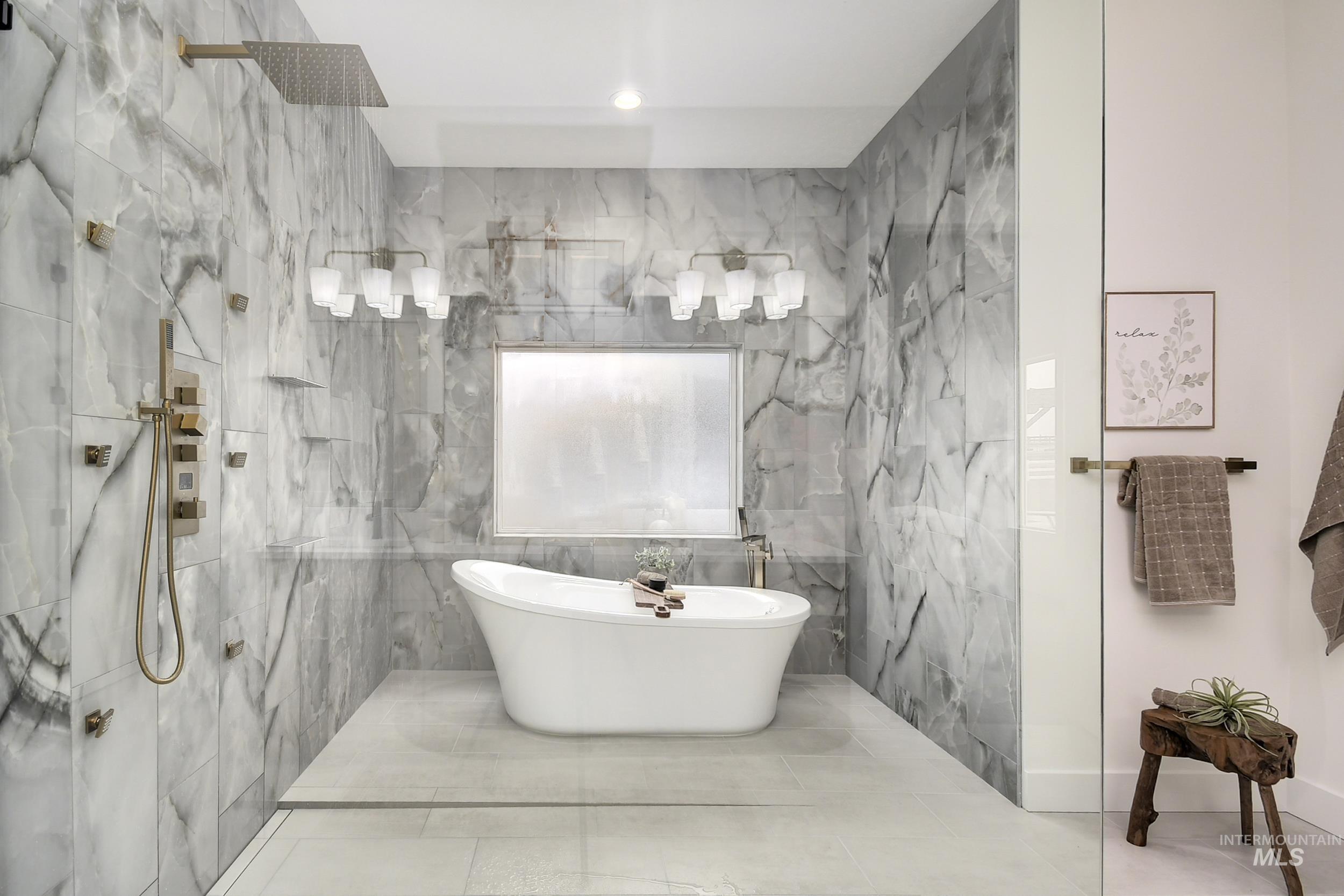 Full bath featuring a marble finish shower, tile walls, and a freestanding bath