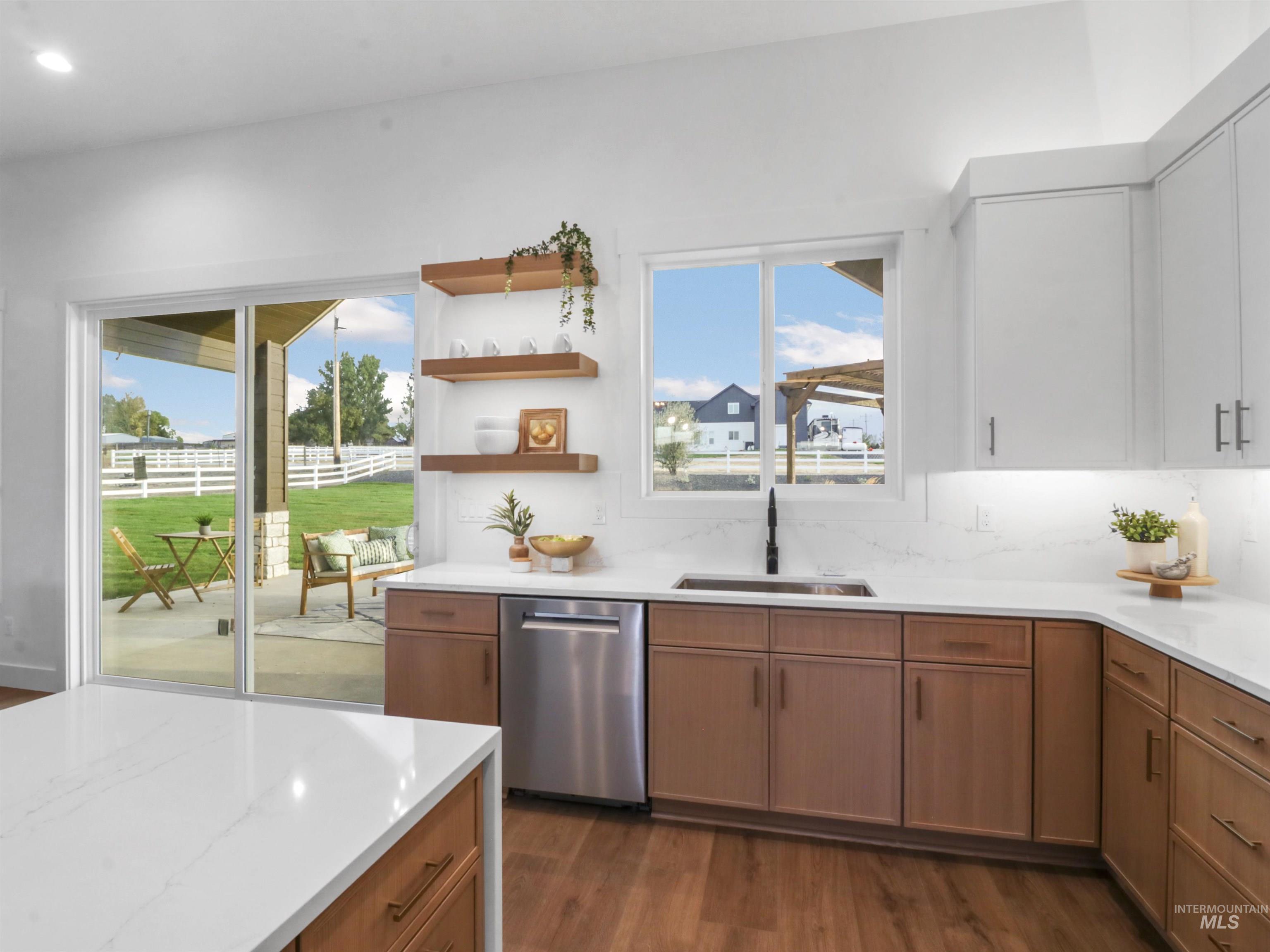 Kitchen featuring dark wood finished floors, open shelves, and stainless steel dishwasher