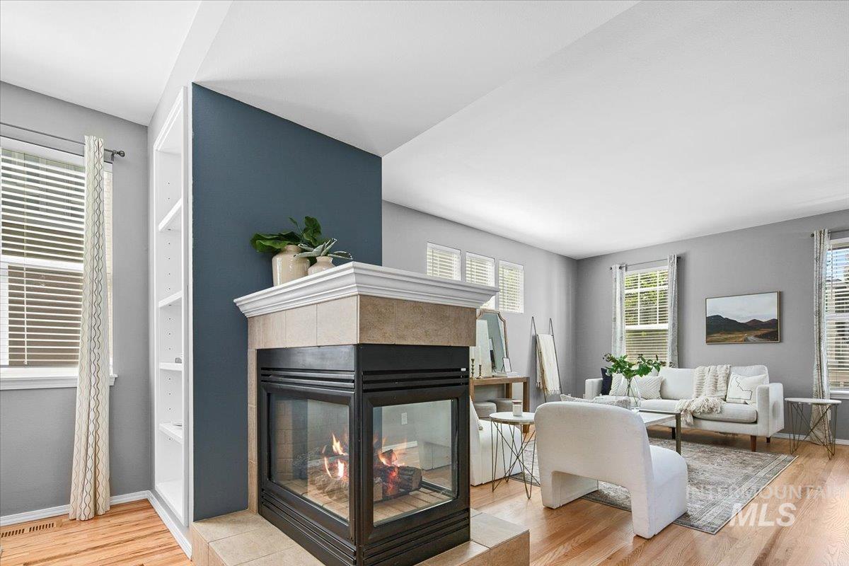 Living area with 3 sided tiled fireplace