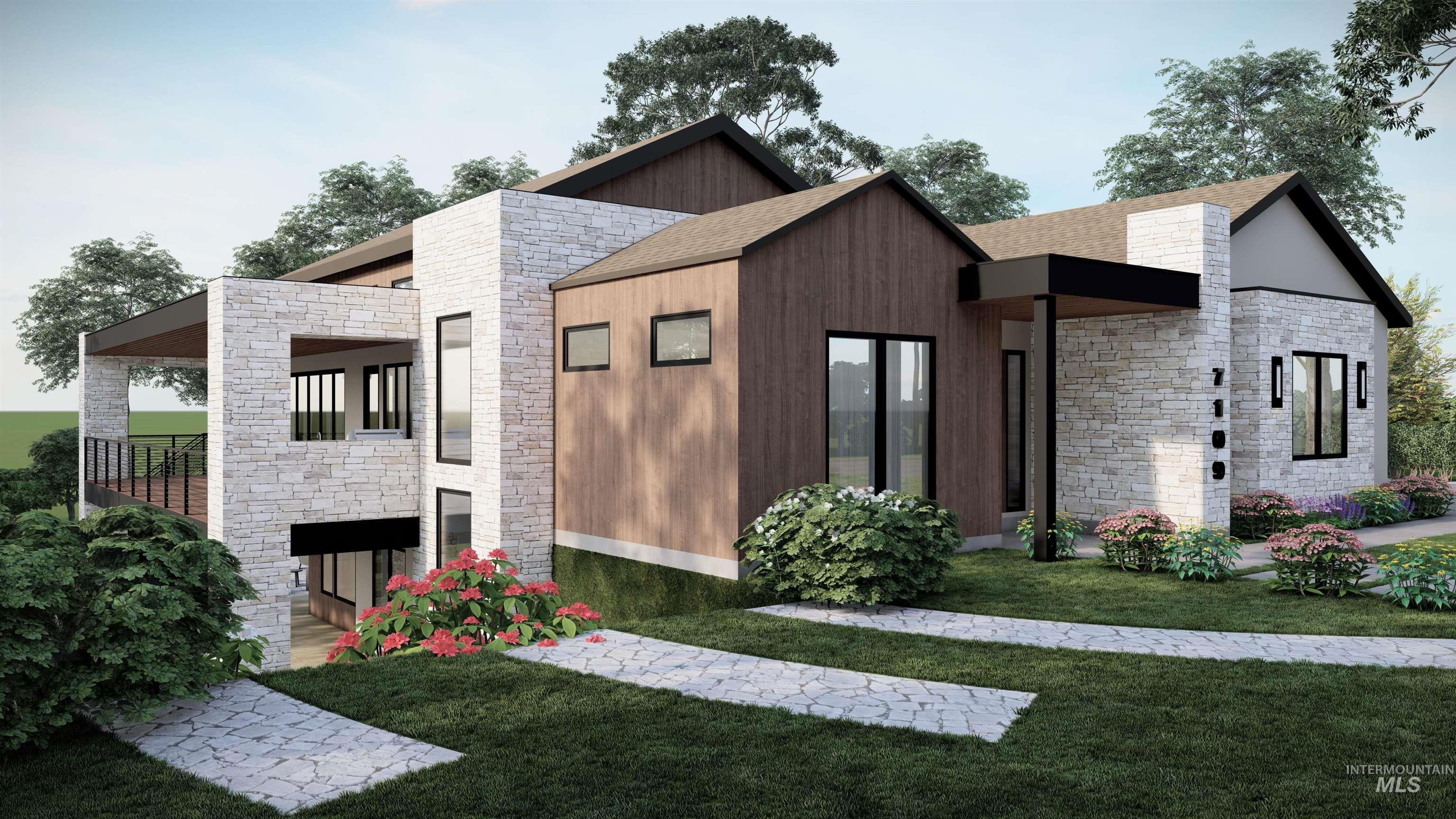 Back of property featuring stone siding and a yard