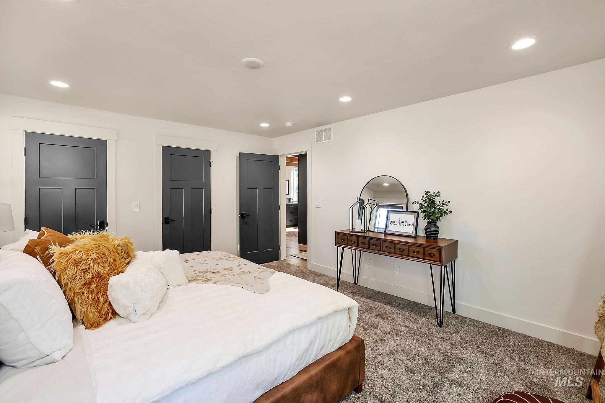 Bedroom featuring a closet, recessed lighting, and carpet