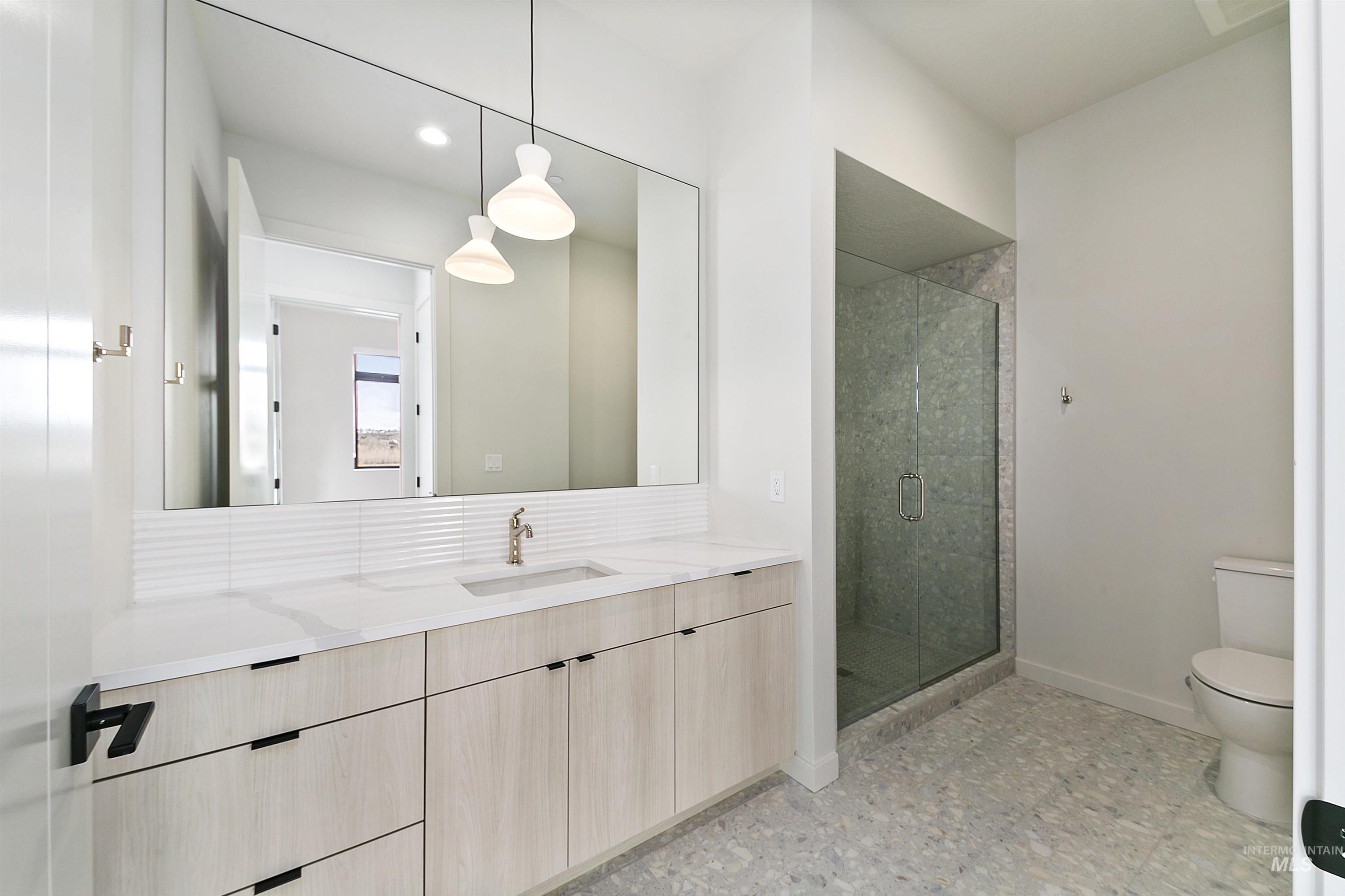 Bathroom featuring a stall shower, vanity, recessed lighting, and light floors