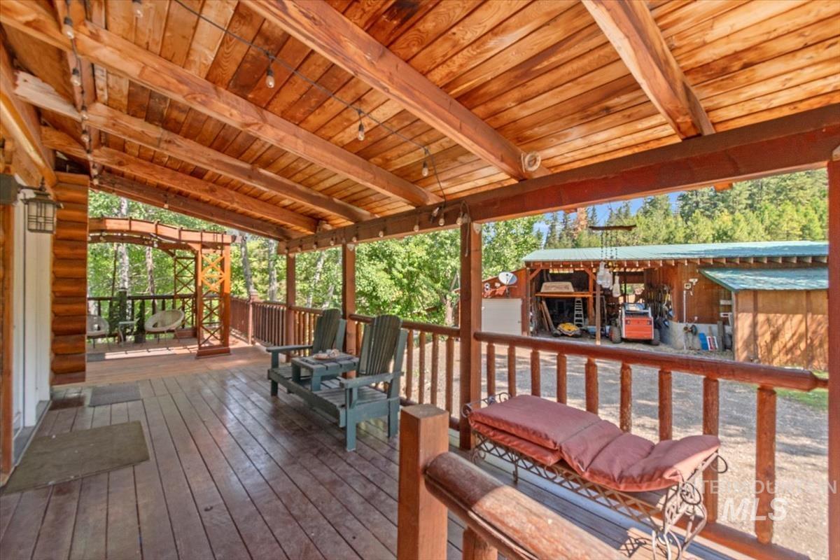 Wooden terrace featuring an outbuilding