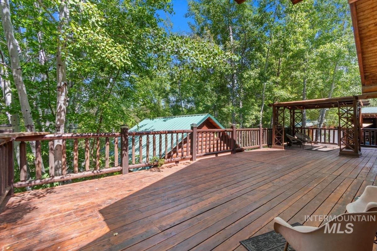 Wooden terrace with view of wooded area