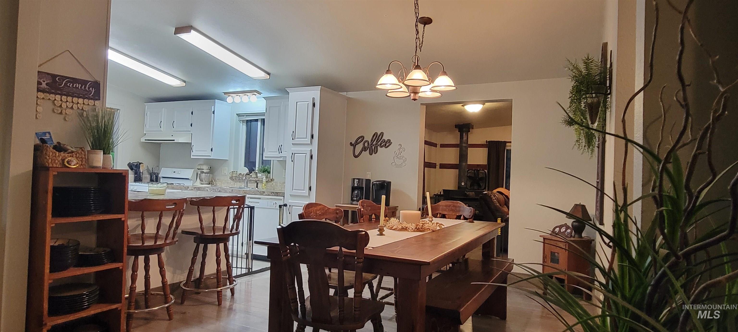Dining space featuring light wood finished floors and a chandelier