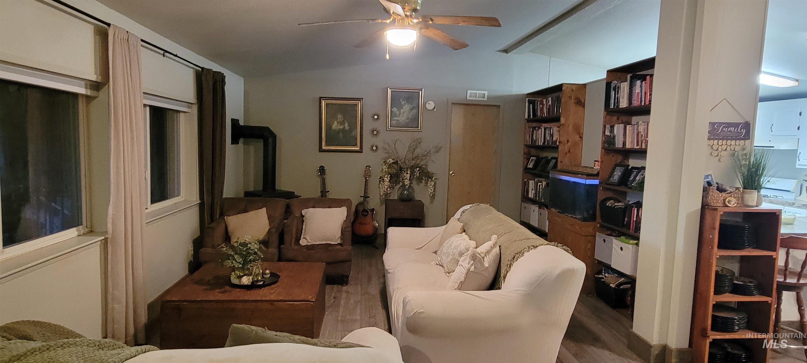 Living area featuring wood finished floors and ceiling fan
