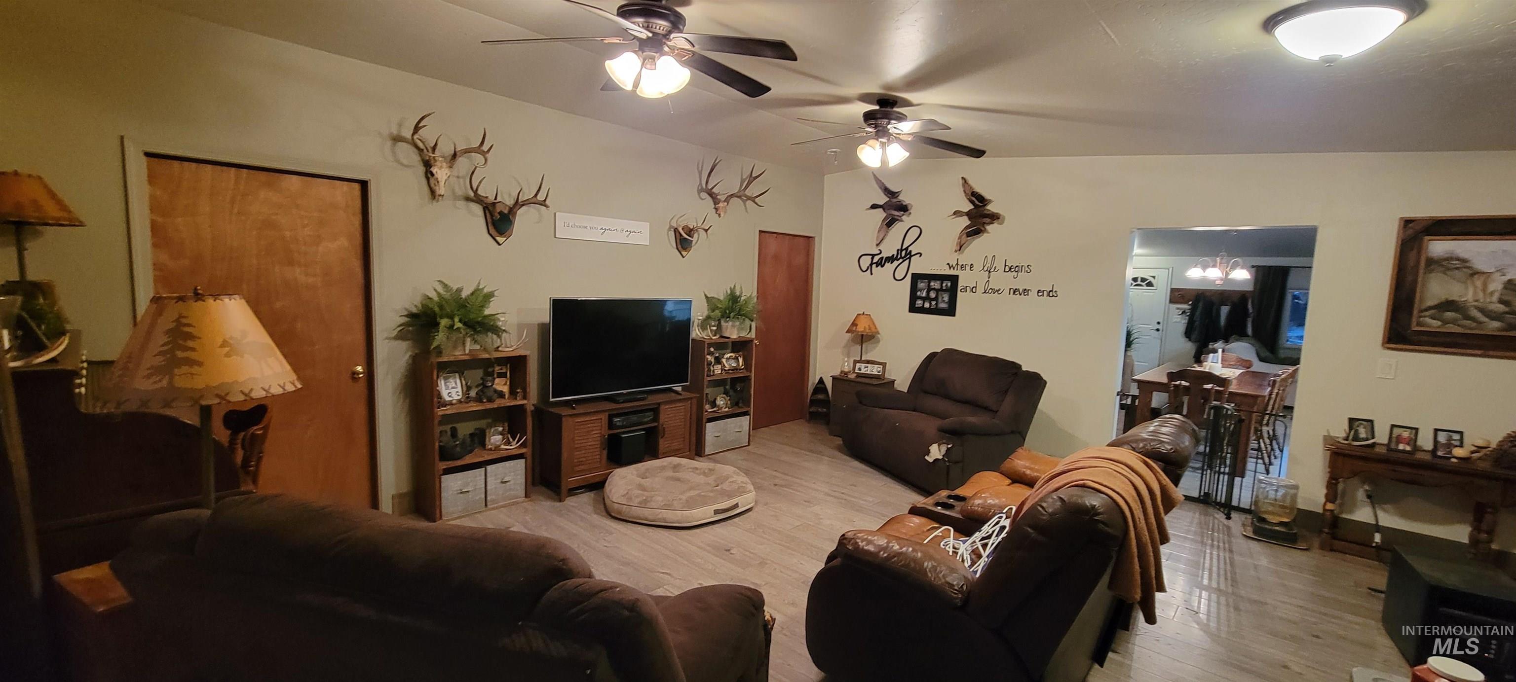 Living area with wood finished floors and a ceiling fan